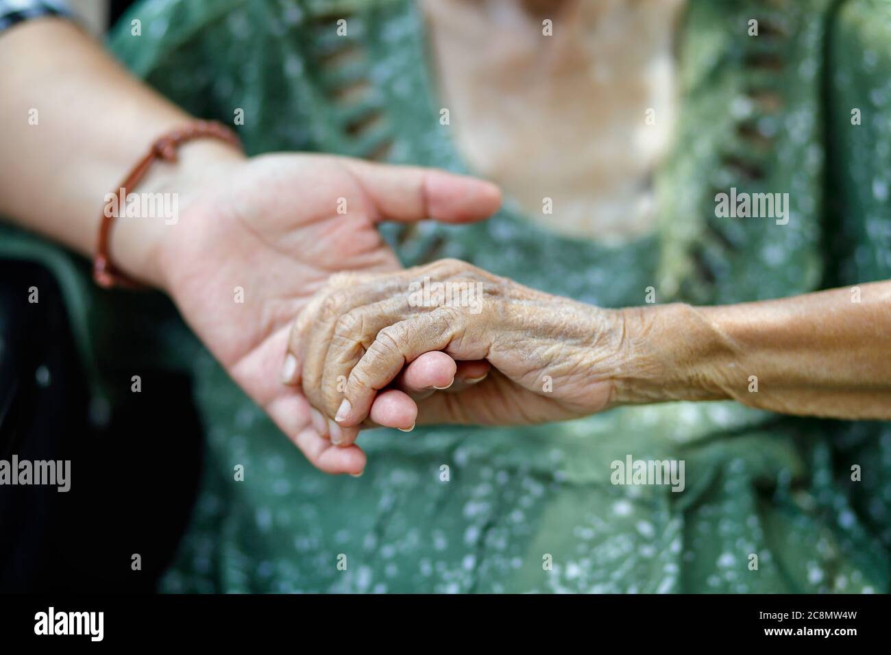Elderly asian woman on wheelchair at home with daughter take care Stock Photo