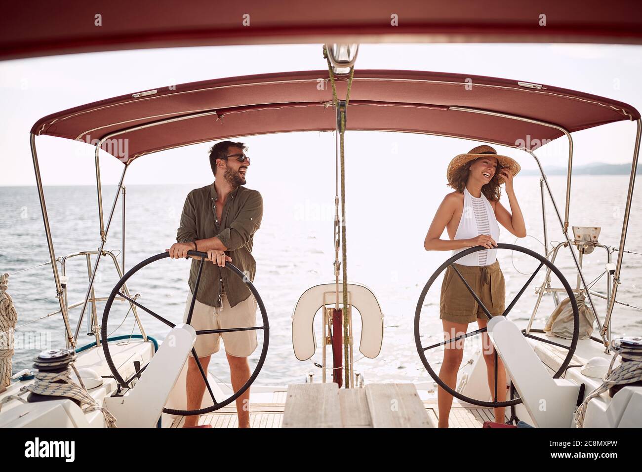 Young couple driving a yacht on a wonderful weather Stock Photo