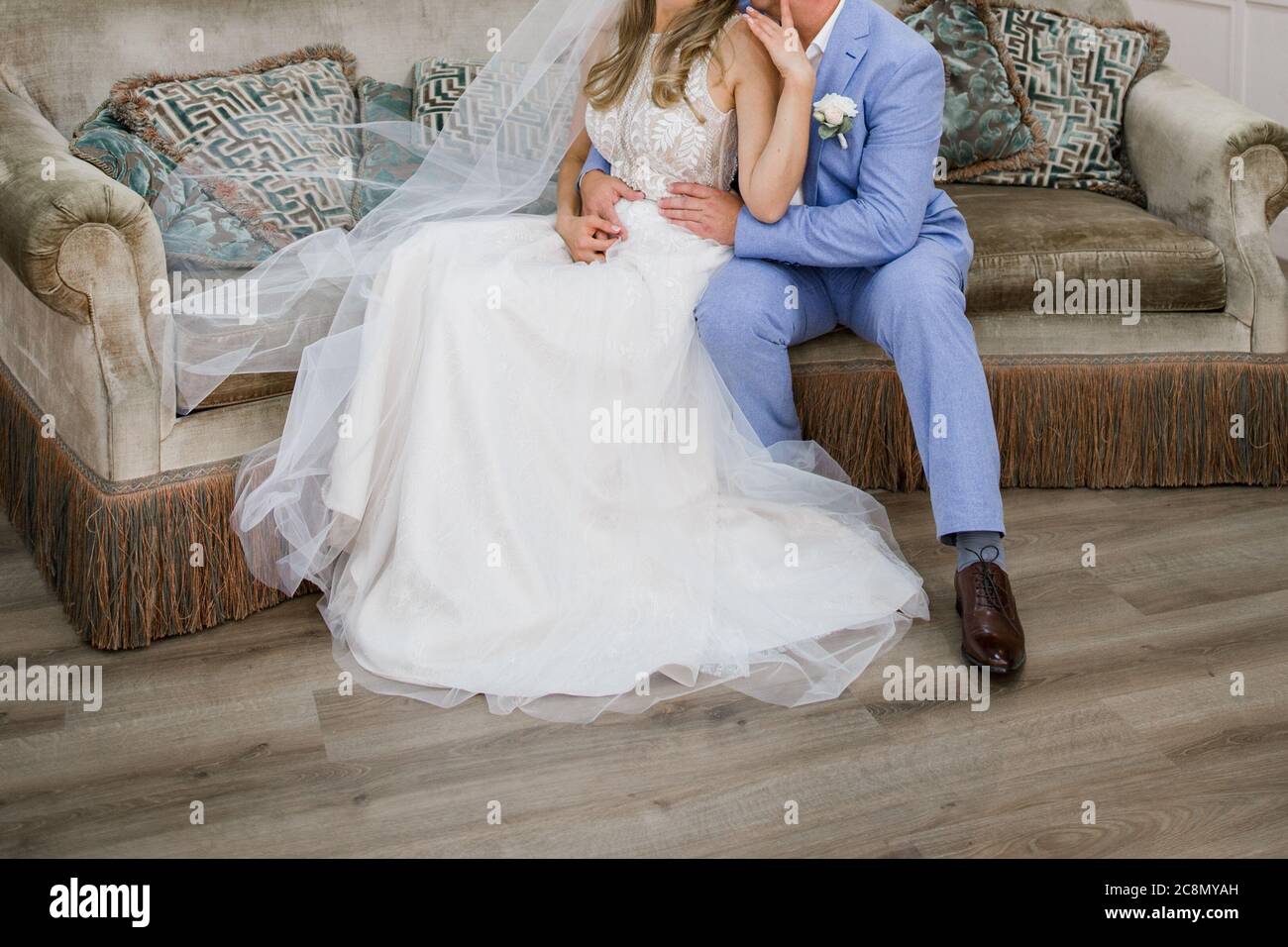 the bride and groom are sitting in a chair Stock Photo - Alamy