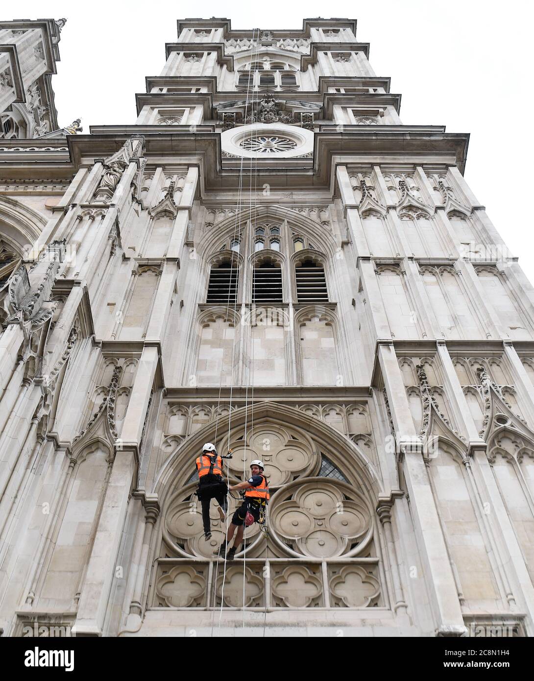 Deputy Clarke of Works Iain McDonald and Industrial Rope Access Trade Association L3 Supervisor Adam Garre abseil down the West Tower of Westminster Abbey, in London, as they check the condition of the stone. Stock Photo