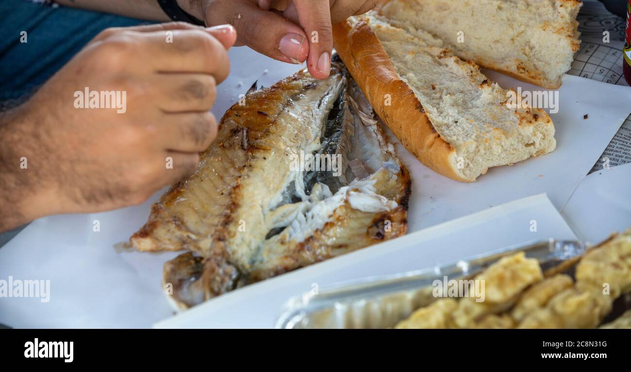 Close up man eating fish Stock Photo - Alamy