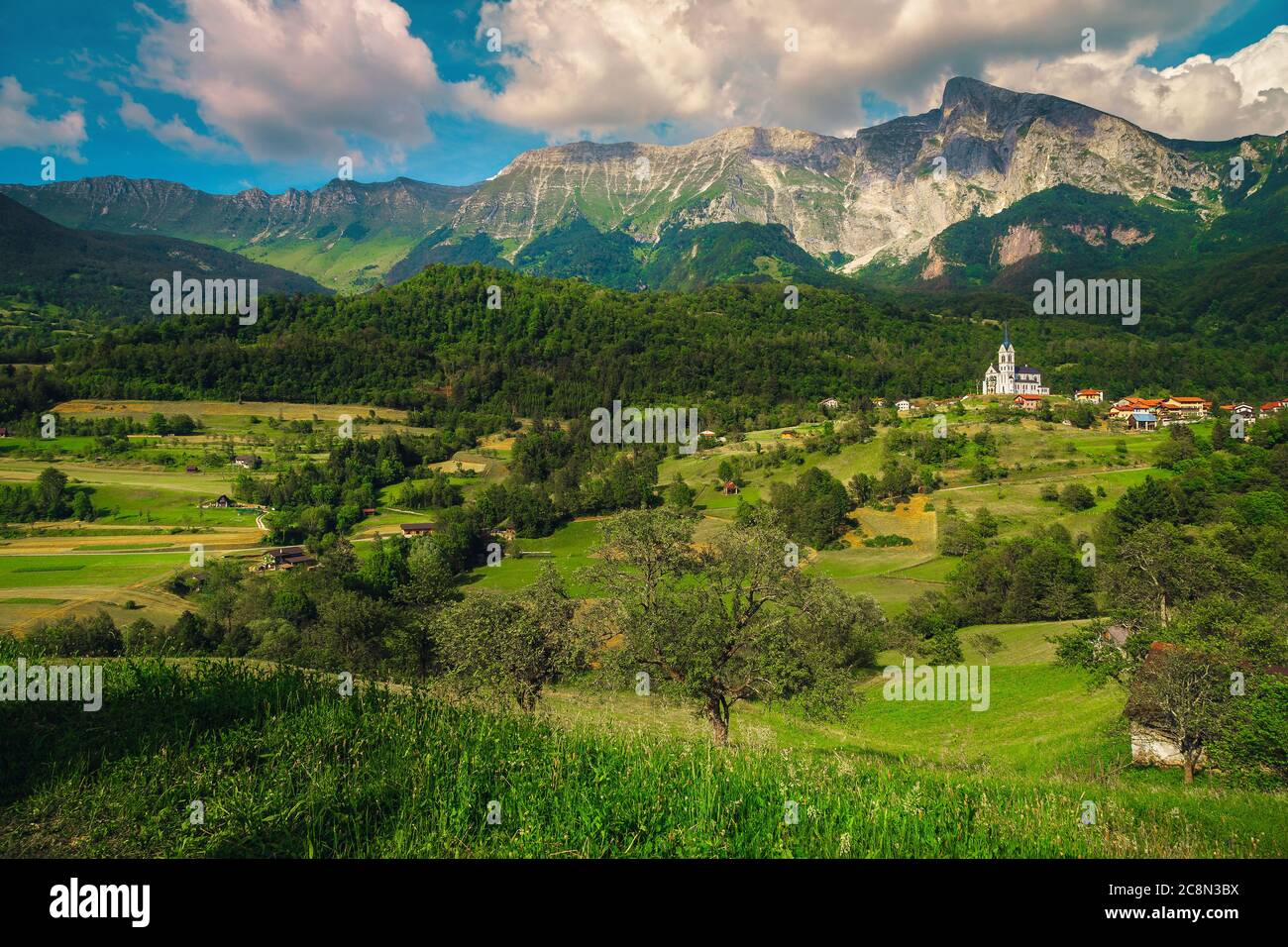 Admirable travel and hiking destination with high rocky mountains and summer green fields, Dreznica village near Kobarid, Soca valley, Slovenia, Europ Stock Photo