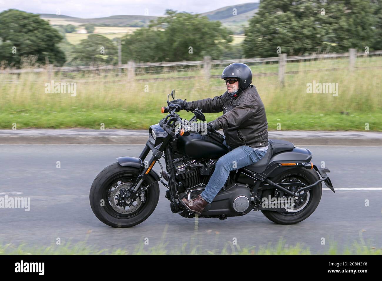 Harley Davidson Motorbike rider; two wheeled transport, motorcycles, vehicle, roads, motorbikes, bike riders motoring in Chorley, UK Stock Photo