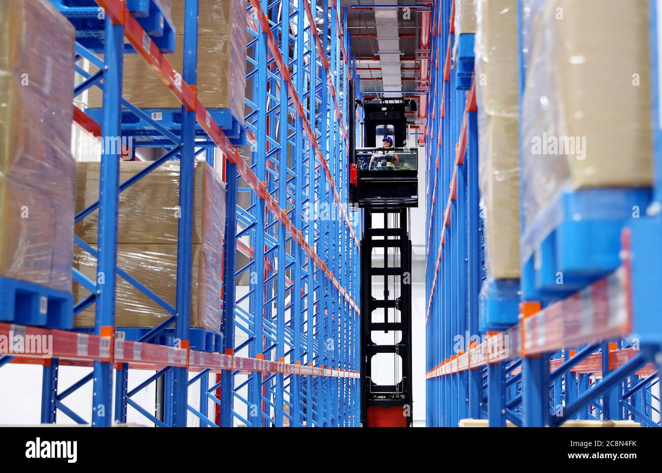 Shanghai, China. 5th June, 2020. A staff member works between storage shelves at Hongqiao Central Business District Bonded Logistics Centre in Shanghai, east China, June 5, 2020. TO GO WITH XINHUA HEADLINES OF JULY 26, 2020 Credit: Fang Zhe/Xinhua/Alamy Live News Stock Photo