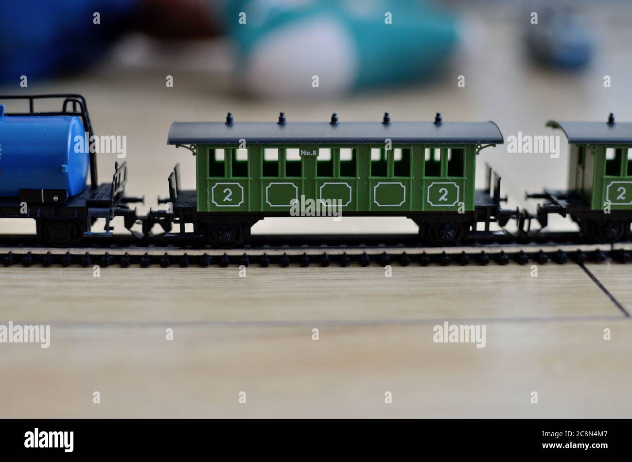 Miniature toy train, old passenger car with metal rails, scale 1:120.  Vintage toy from 80's Stock Photo - Alamy