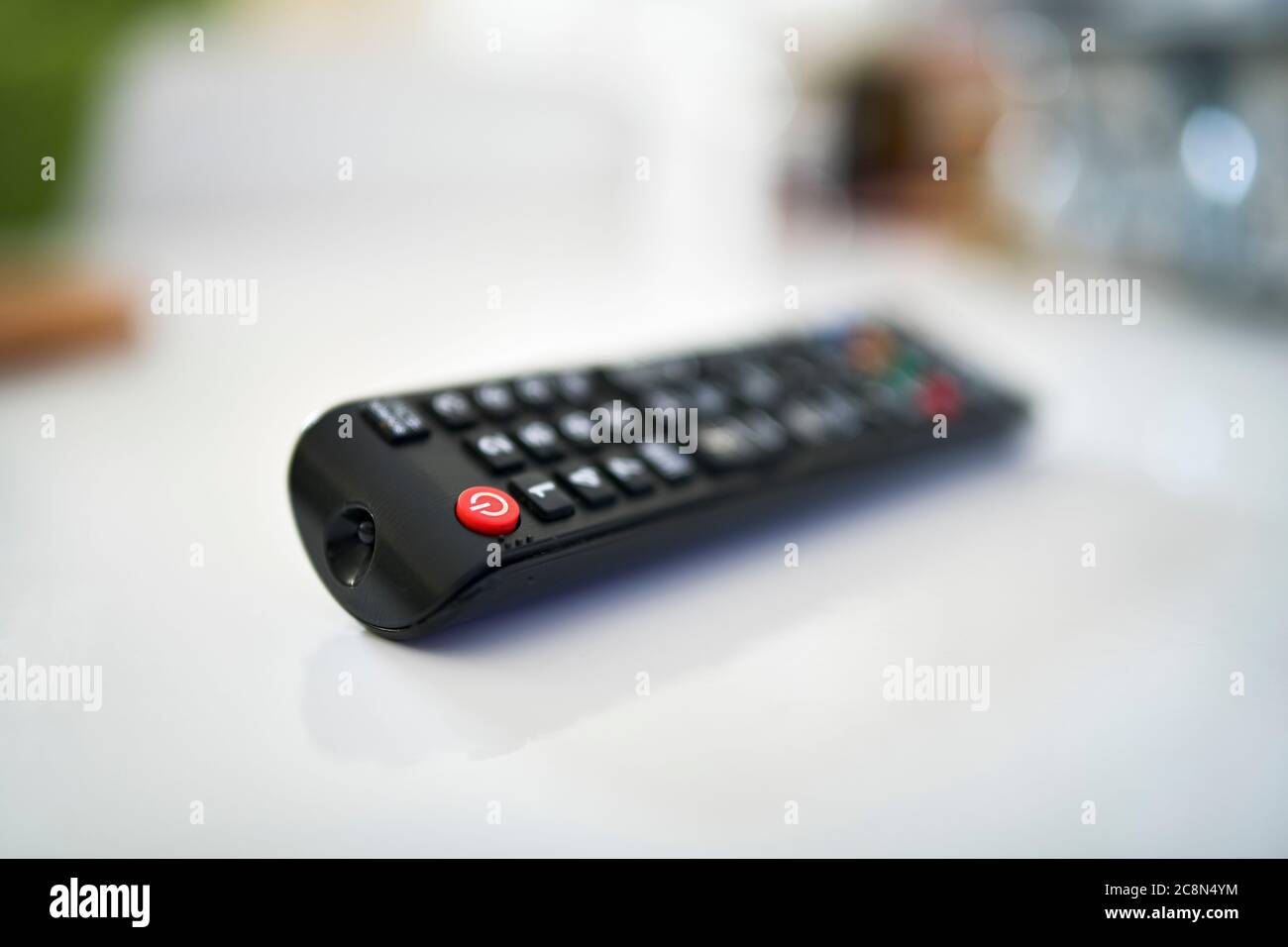 Close up of a TV remote on white background, shallow depth of the field. Stock Photo