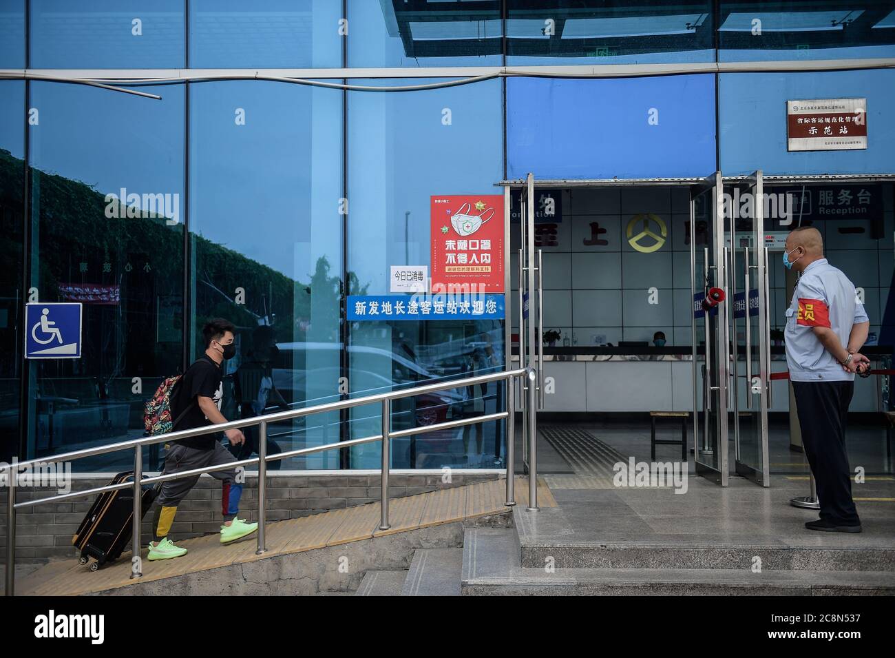 Beijing, China. 26th July, 2020. A passenger enters the reopened Xinfadi intercity bus terminal in Beijing, capital of China, July 26, 2020. Long-distance bus travel services have resumed Sunday at Beijing's Xinfadi intercity bus terminal as COVID-19 situation comes under control. Credit: Peng Ziyang/Xinhua/Alamy Live News Stock Photo