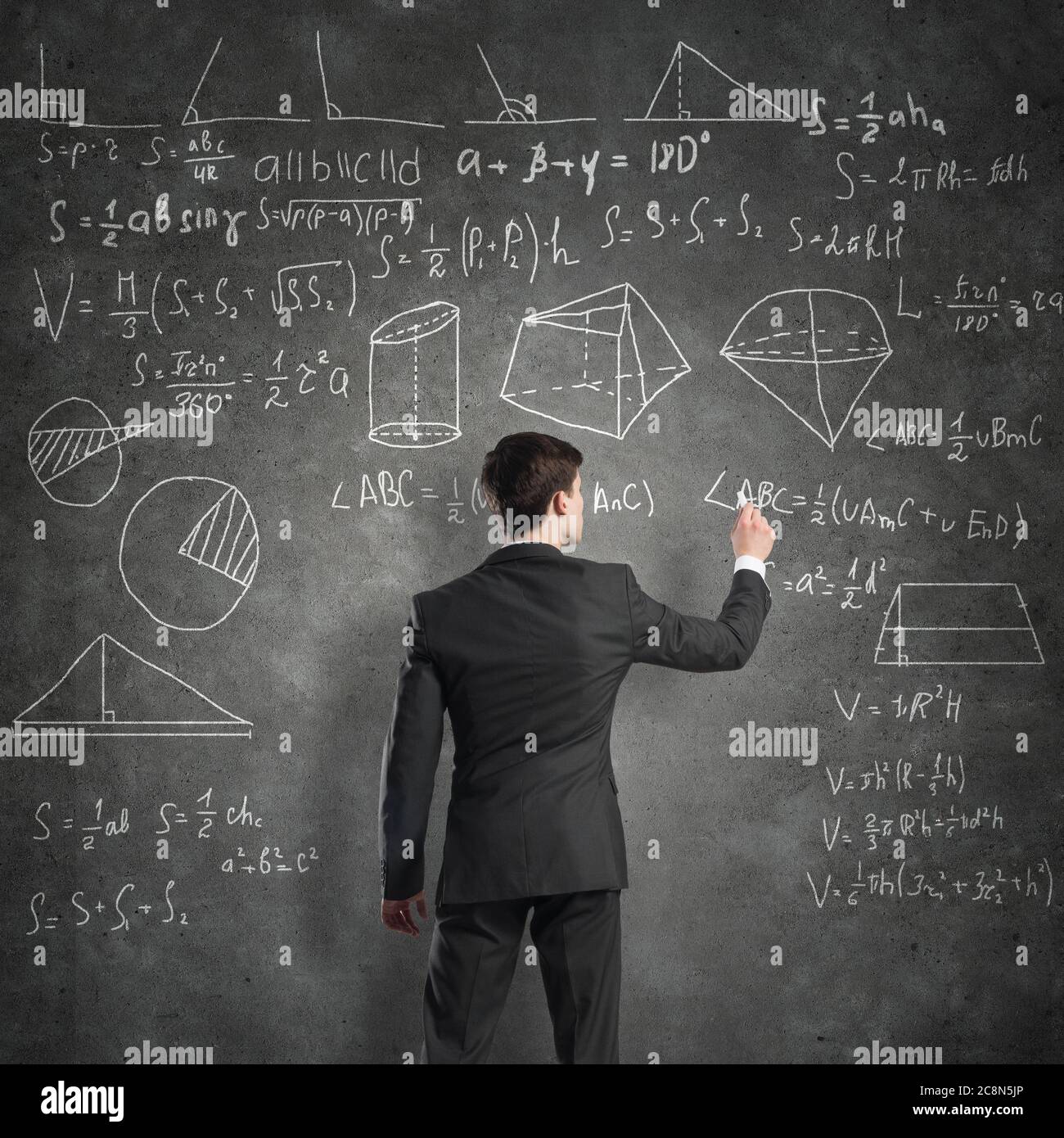 Teacher writing calculations on blackboard hi-res stock photography and ...