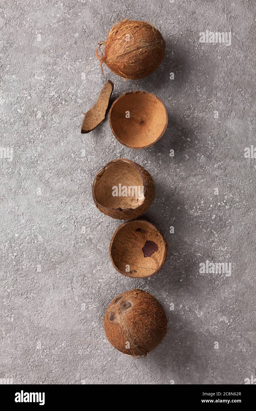 Coconuts whole and broken on gray concrete. Stock Photo