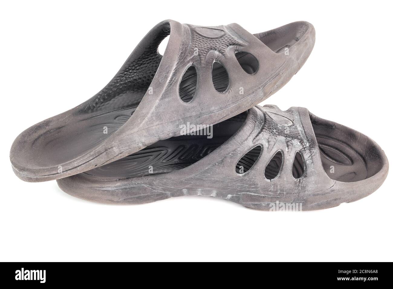 pair of used cheap black soft rubber slippers with signs od friction