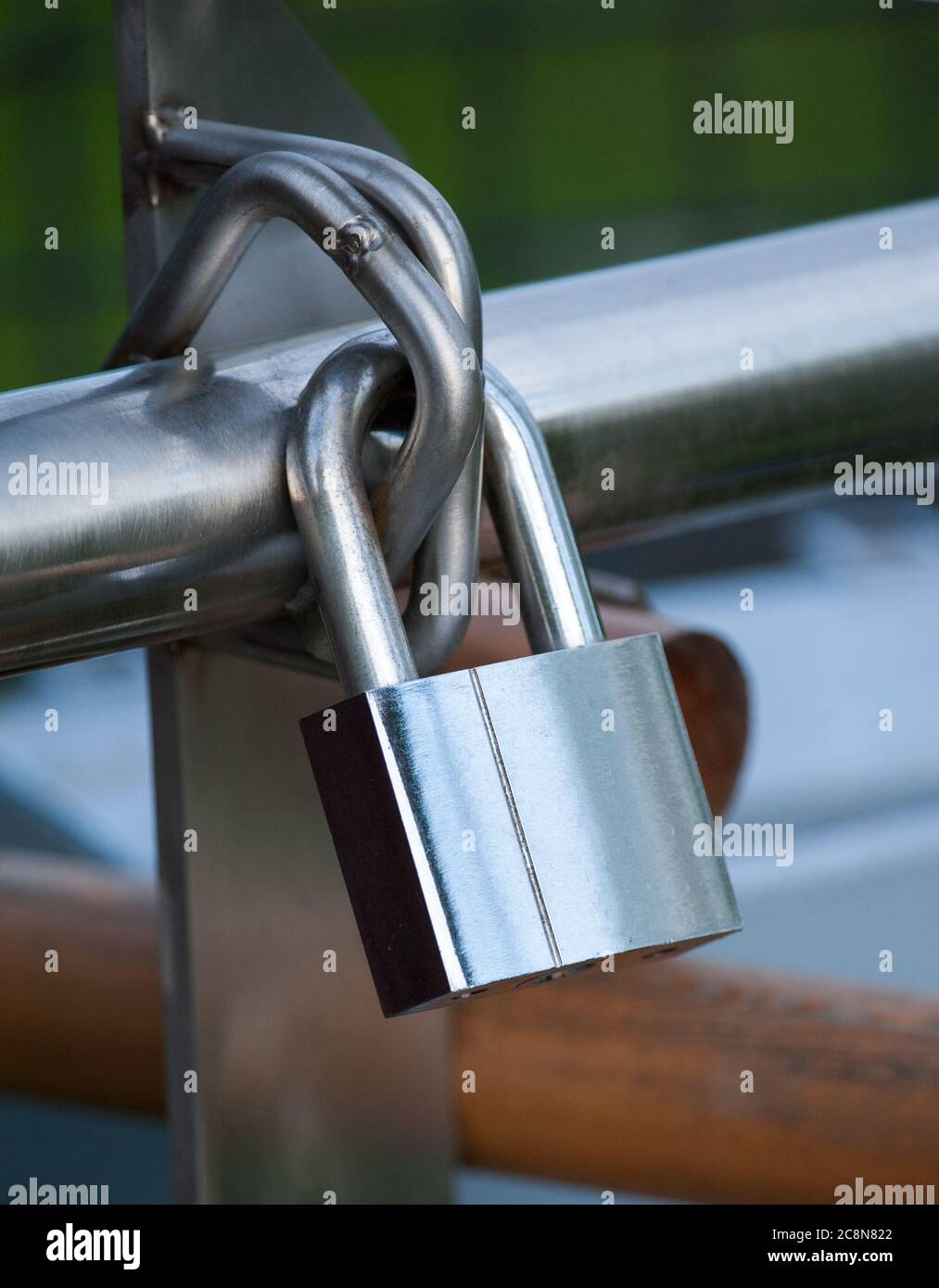 padlock hanging on a fence Stock Photo