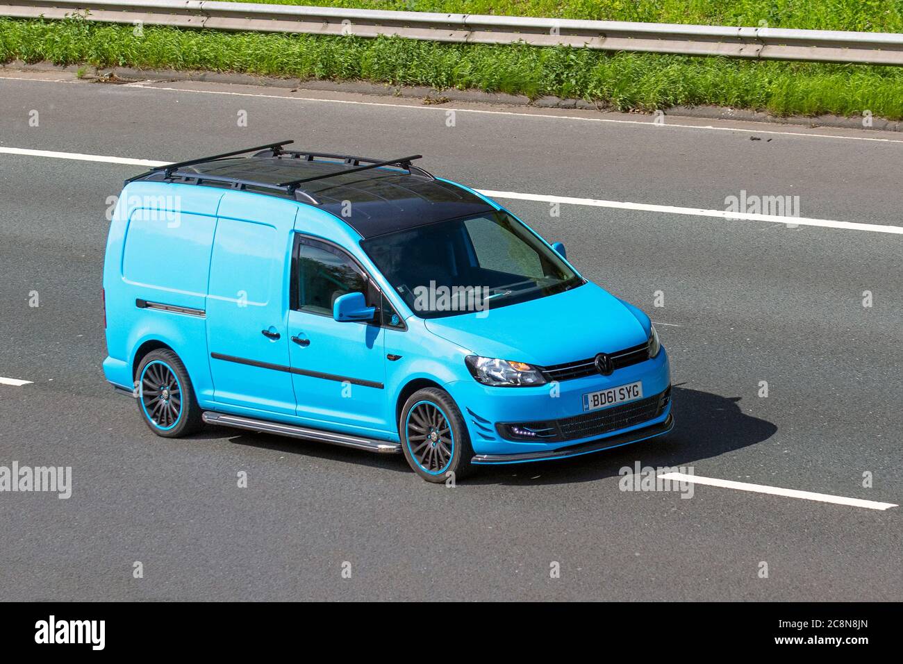 2011 blue VW Volkswagen Caddy Maxi 1.6 TDI BlueMotion Tech C20 Maxi Panel Van 5dr; Vehicular traffic moving vehicles, cars driving vehicle on UK roads, motors, motoring on the M6 motorway highway network. Stock Photo