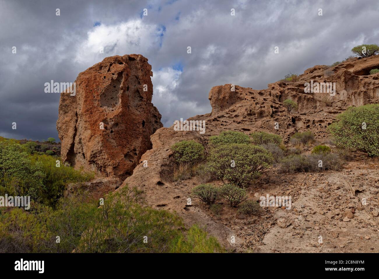A detached eroded Volcanic Breccia Boulder standing upright on the Valley Floor of a Nature Reserve in Tenerife. Stock Photo