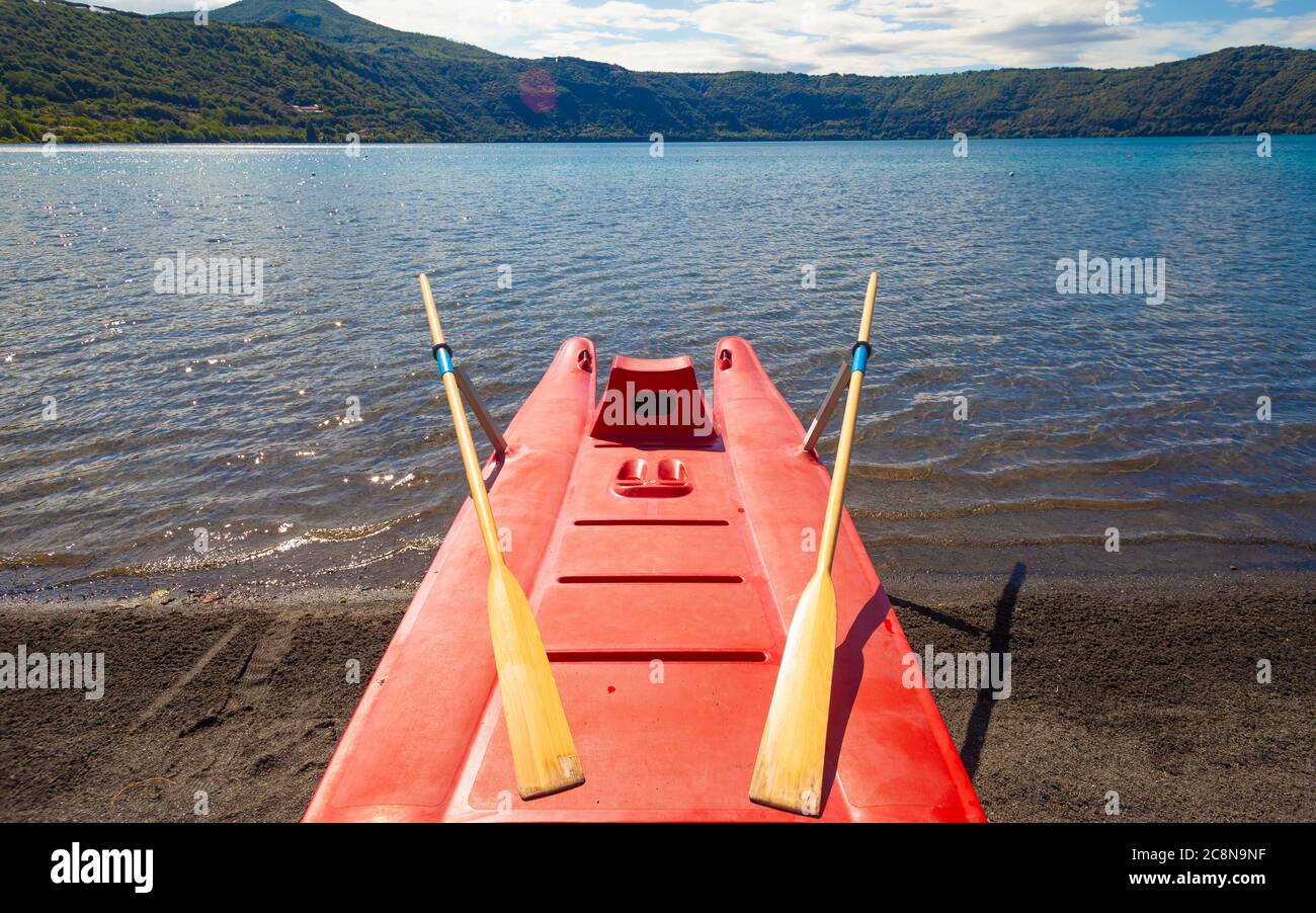 Red Rescue Rowing Boat on lake shoreline Stock Photo