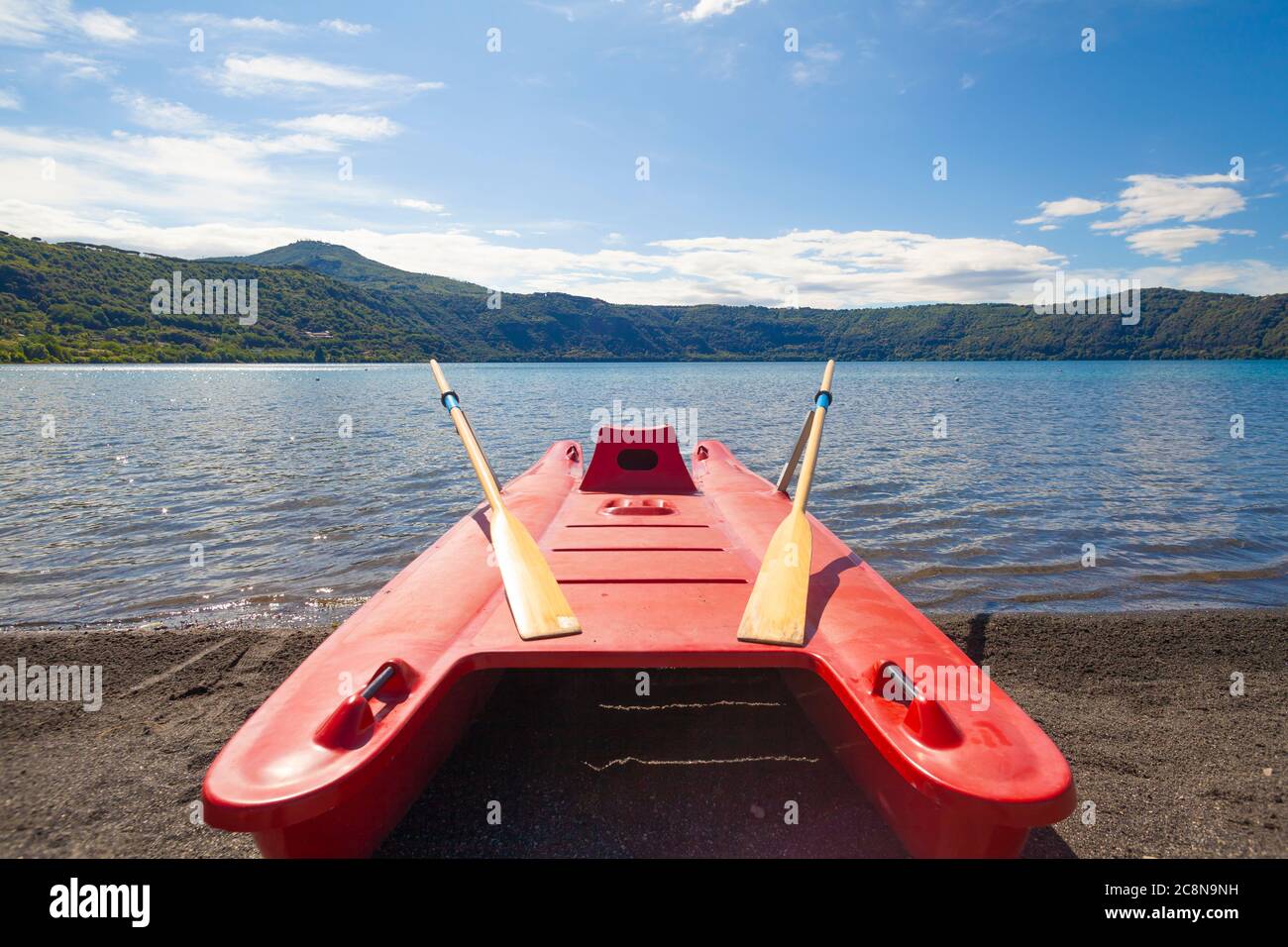 Red Rescue Rowing Boat on lake shoreline Stock Photo