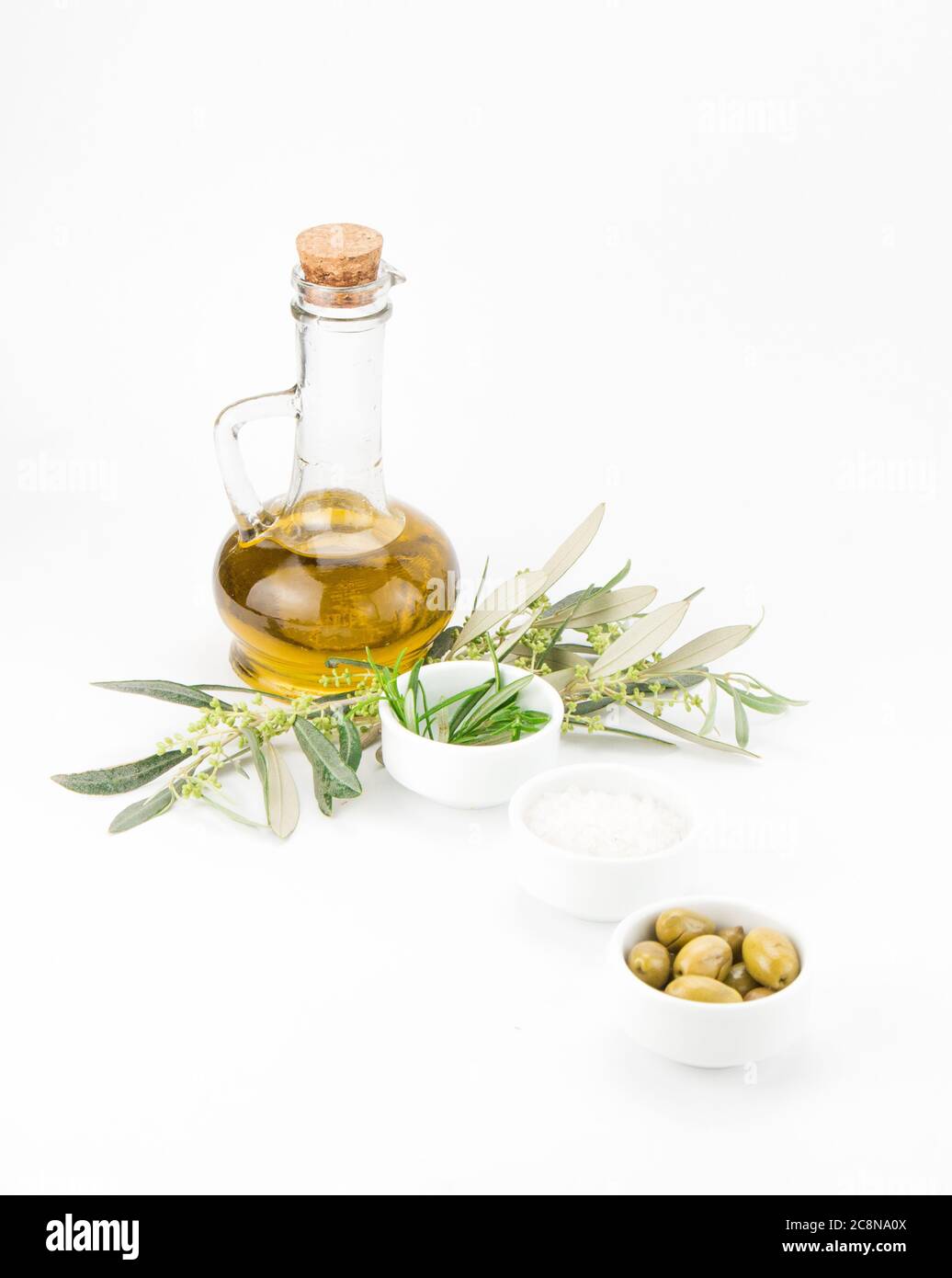 Glass bottle of premium virgin olive oil, rosemary, and some olives ...