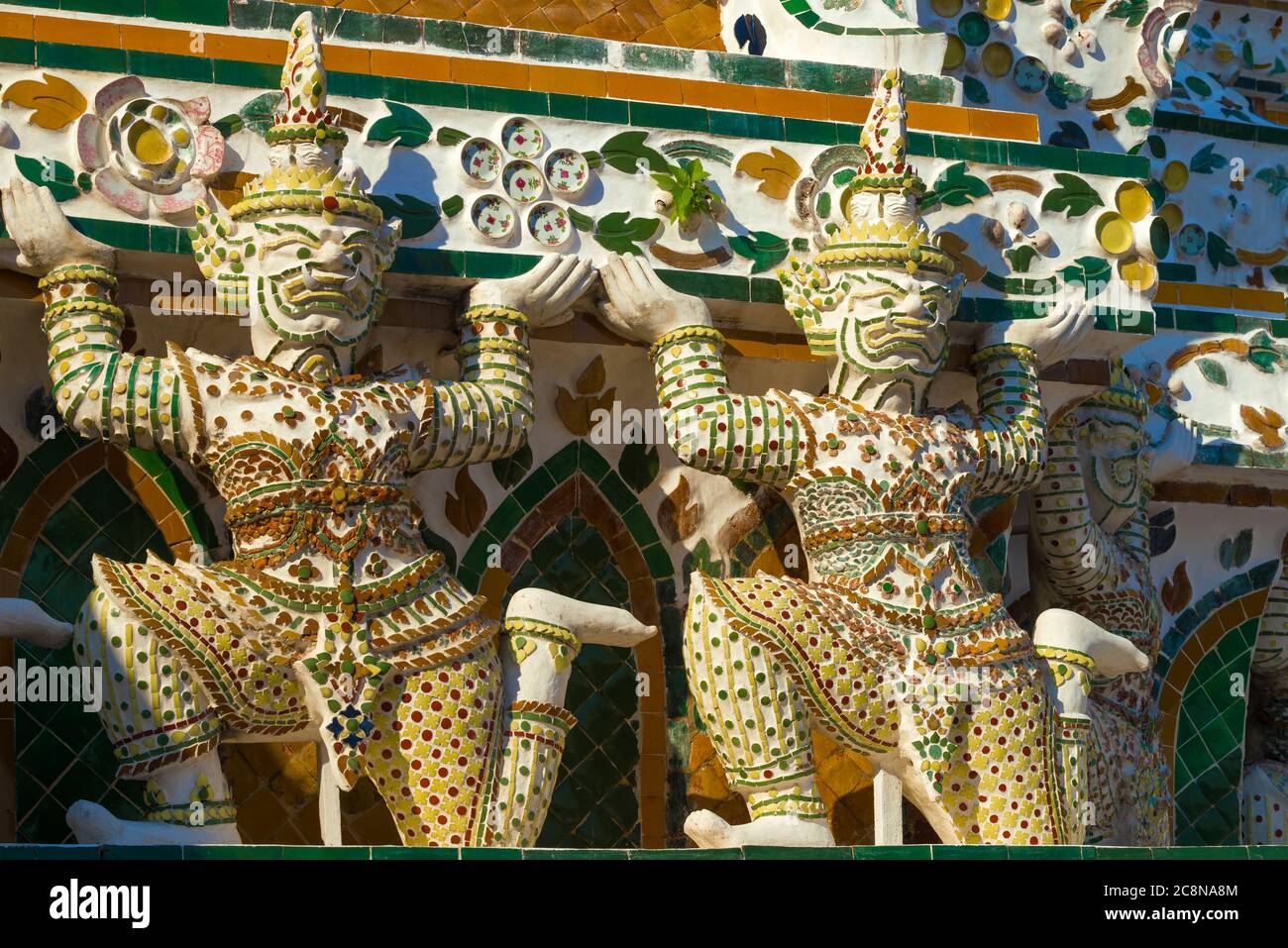 Sculptures of Rakshasa demons supporting the main prang of the Temple of the Morning Dawn (Wat Arun). Bangkok, Thailand Stock Photo