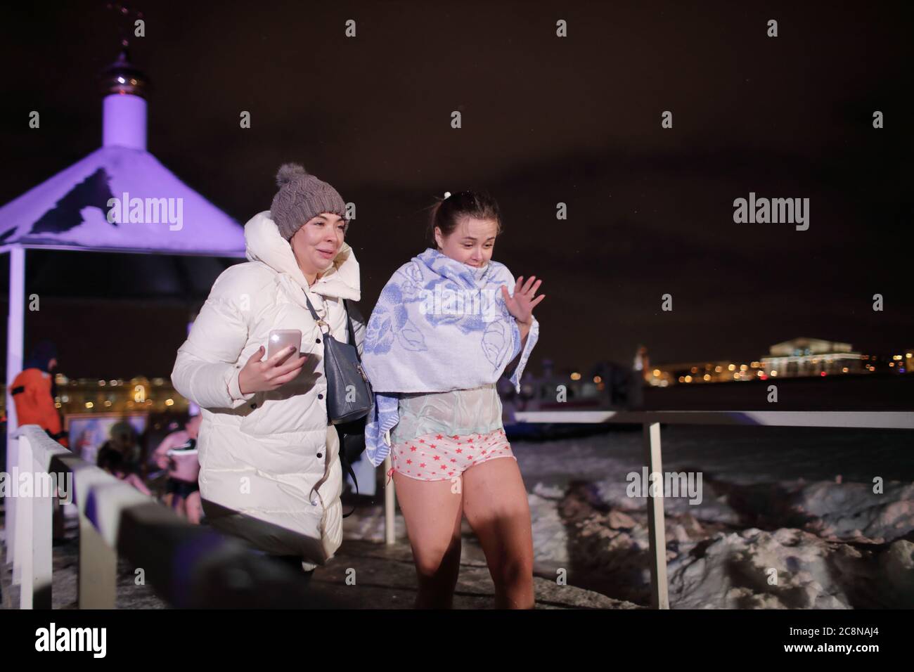 Russian women going from ice bath during celebrating  Epiphany in Saint Petersburg, Russia Stock Photo