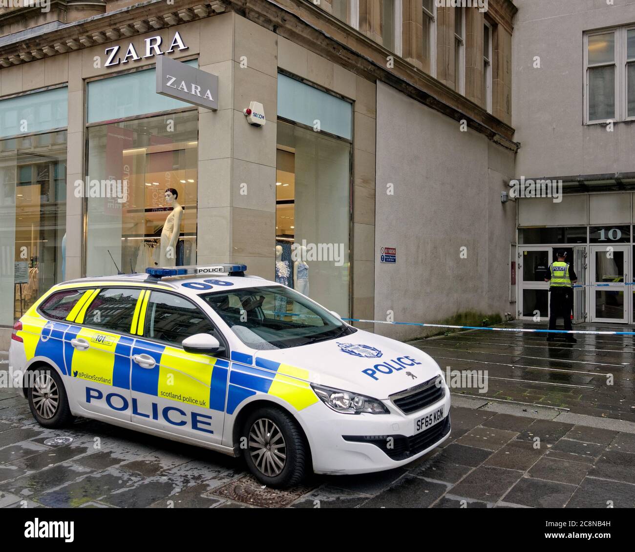Glasgow, Scotland, UK 26th July, 2020:Police cars were parked outside the  Buchanan building and the entrance was taped off with officers guarding no.  10 between Zara and Argyle street in Buchanan Street,
