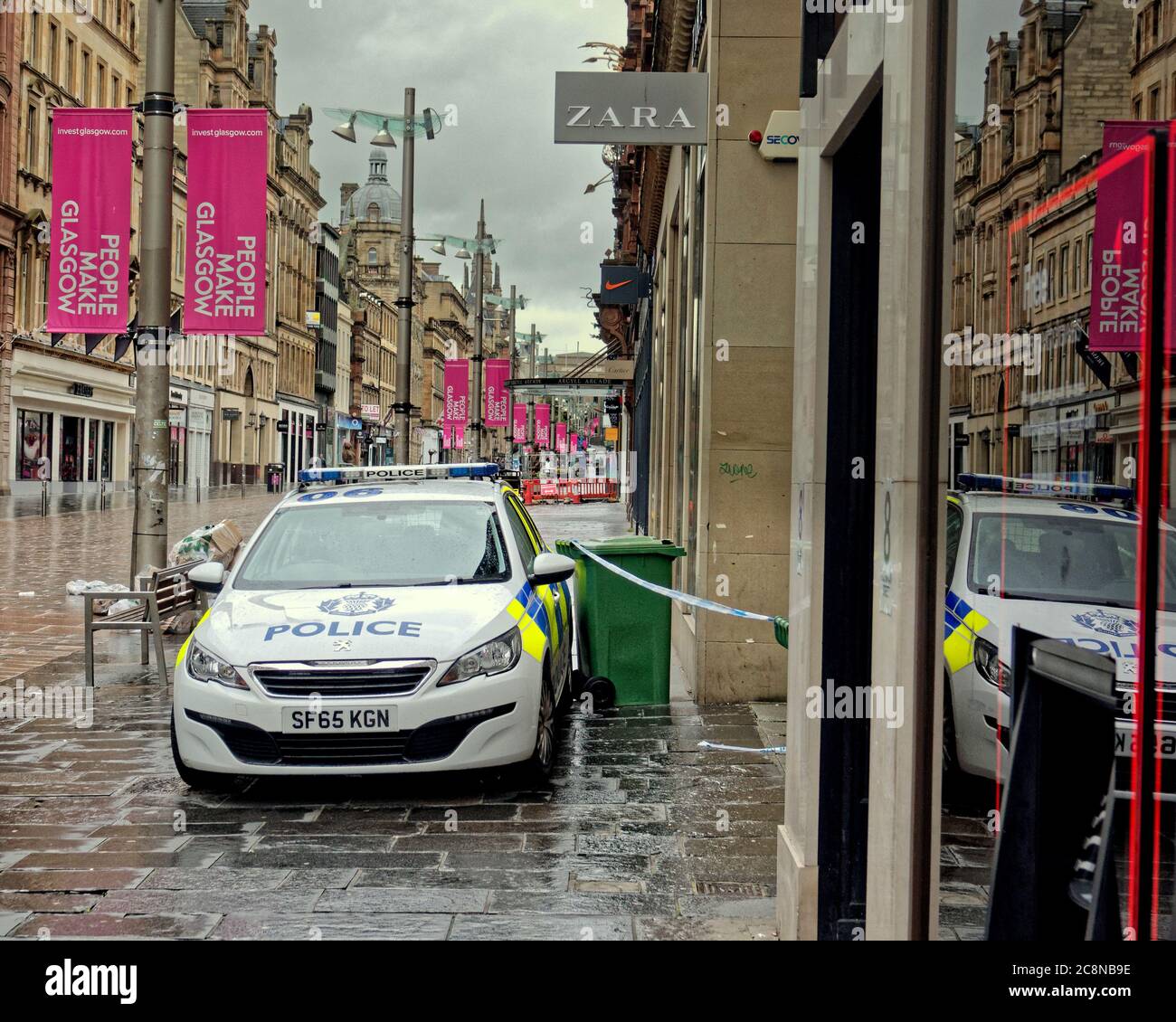 Glasgow, Scotland, UK 26th July, 2020:Police cars were parked outside the  Buchanan building and the entrance was taped off with officers guarding no.  10 between Zara and Argyle street in Buchanan Street,