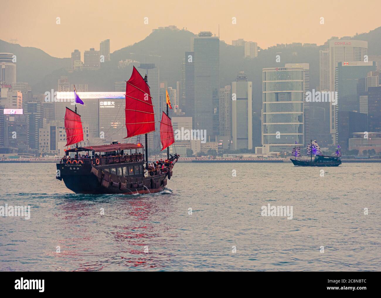 Aqualuna and Aqualuna 2 junk tourist boats on their sunset sailing, Victoria Harbour, Hong Kong Stock Photo