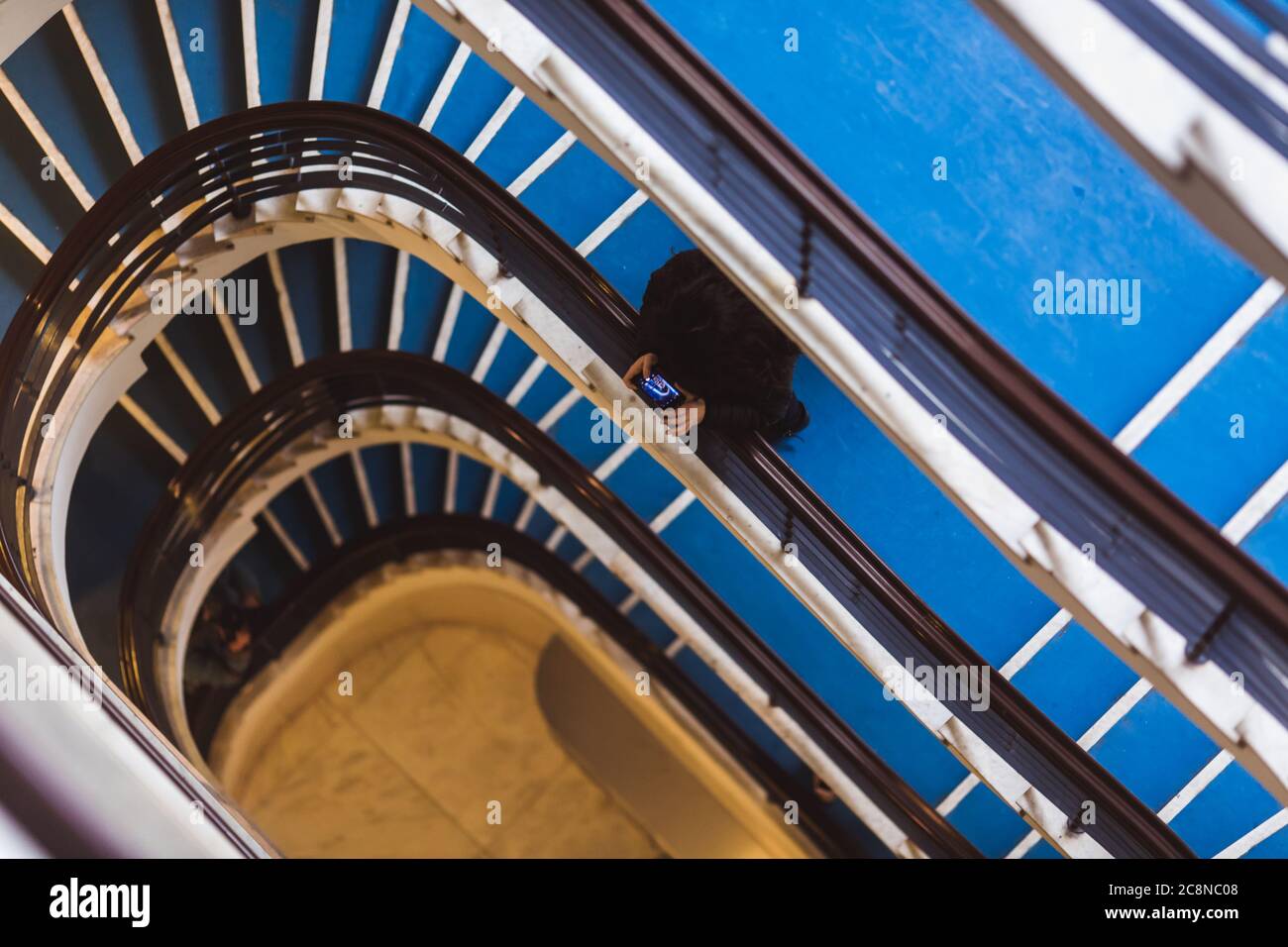 Old blue spiral staircase, spiral stairway inside an old house in Budapest, Hungary. Project Budapest 100 Stock Photo