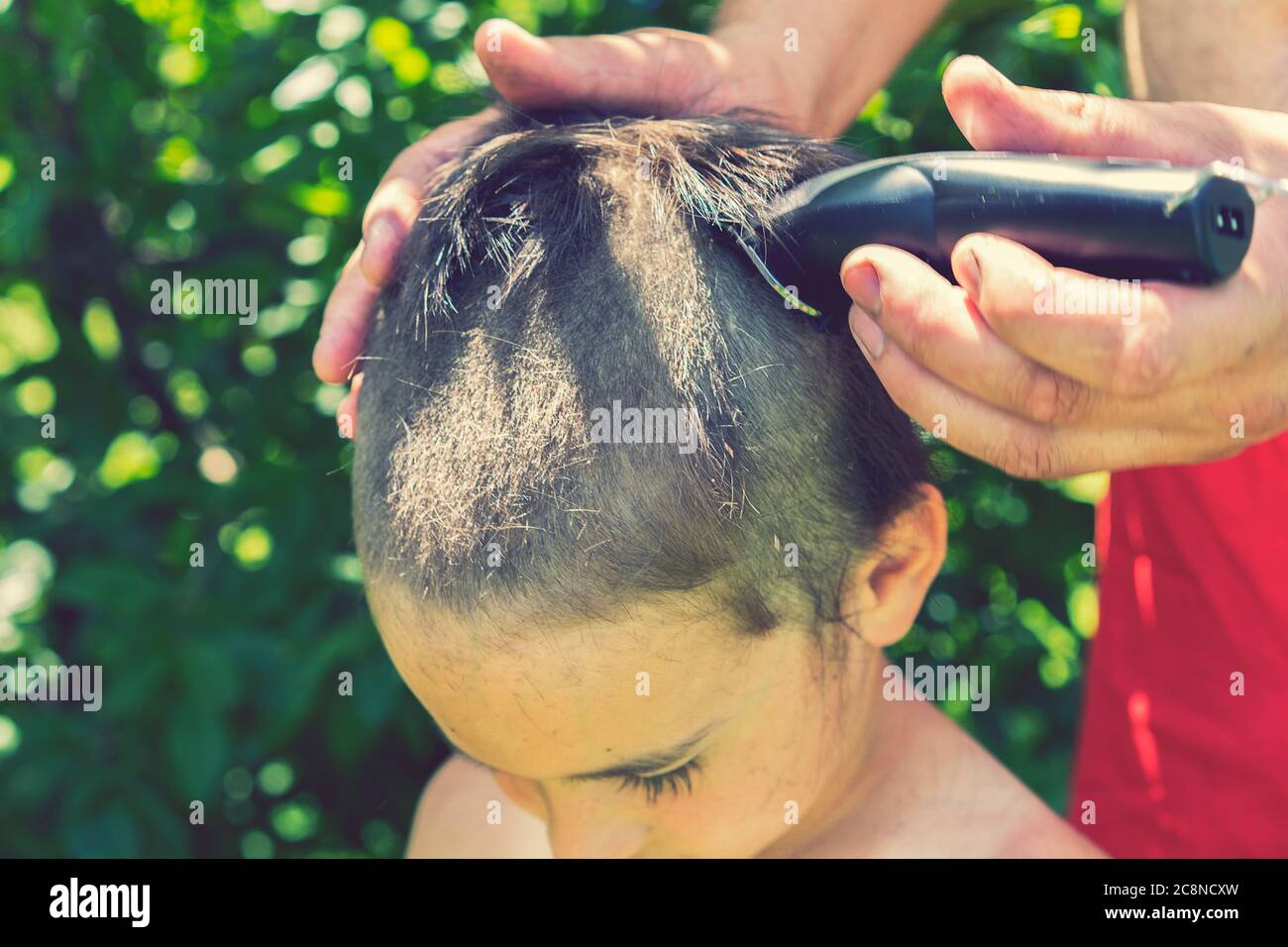 cutting long hair with electric clippers