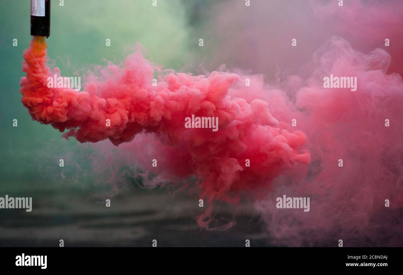coloroful pink smoke bombs in action Stock Photo