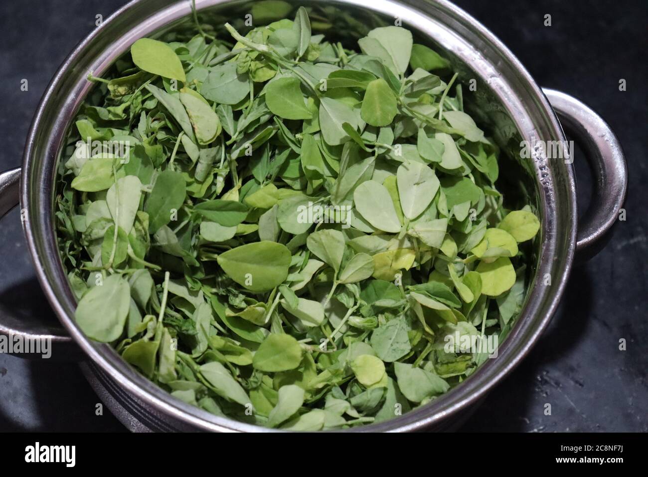Raw Organic Fenugreek Methi Leaves in a Bowl Stock Photo