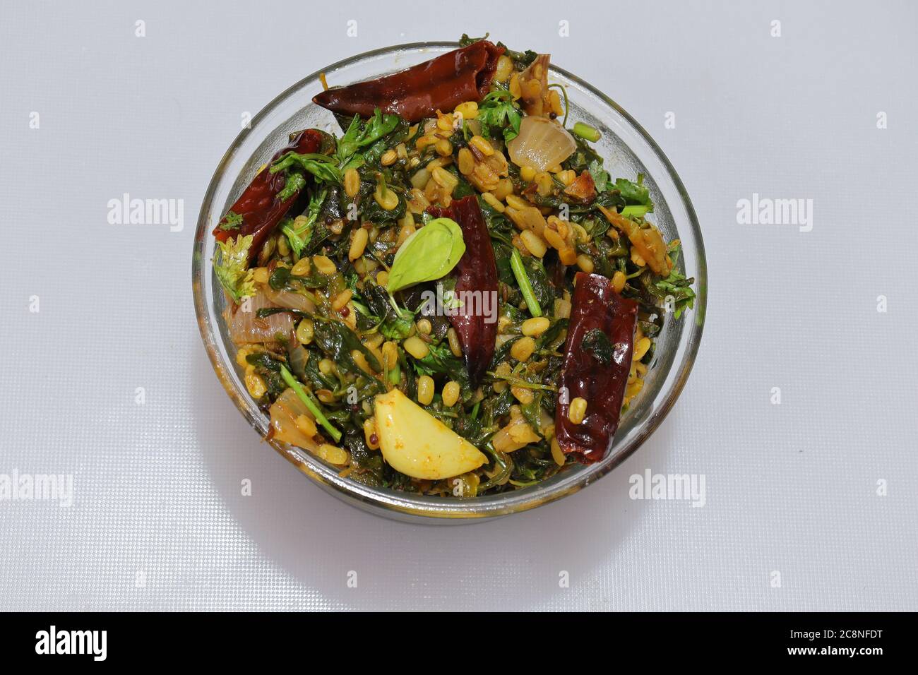 Raw Organic Fenugreek Methi Leaves curry in a glass bowl Stock Photo