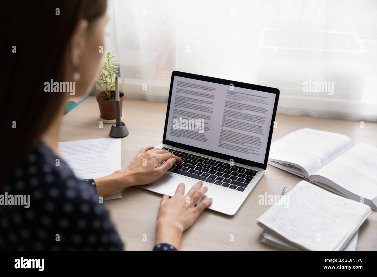 Back view of female student work study on laptop Stock Photo - Alamy