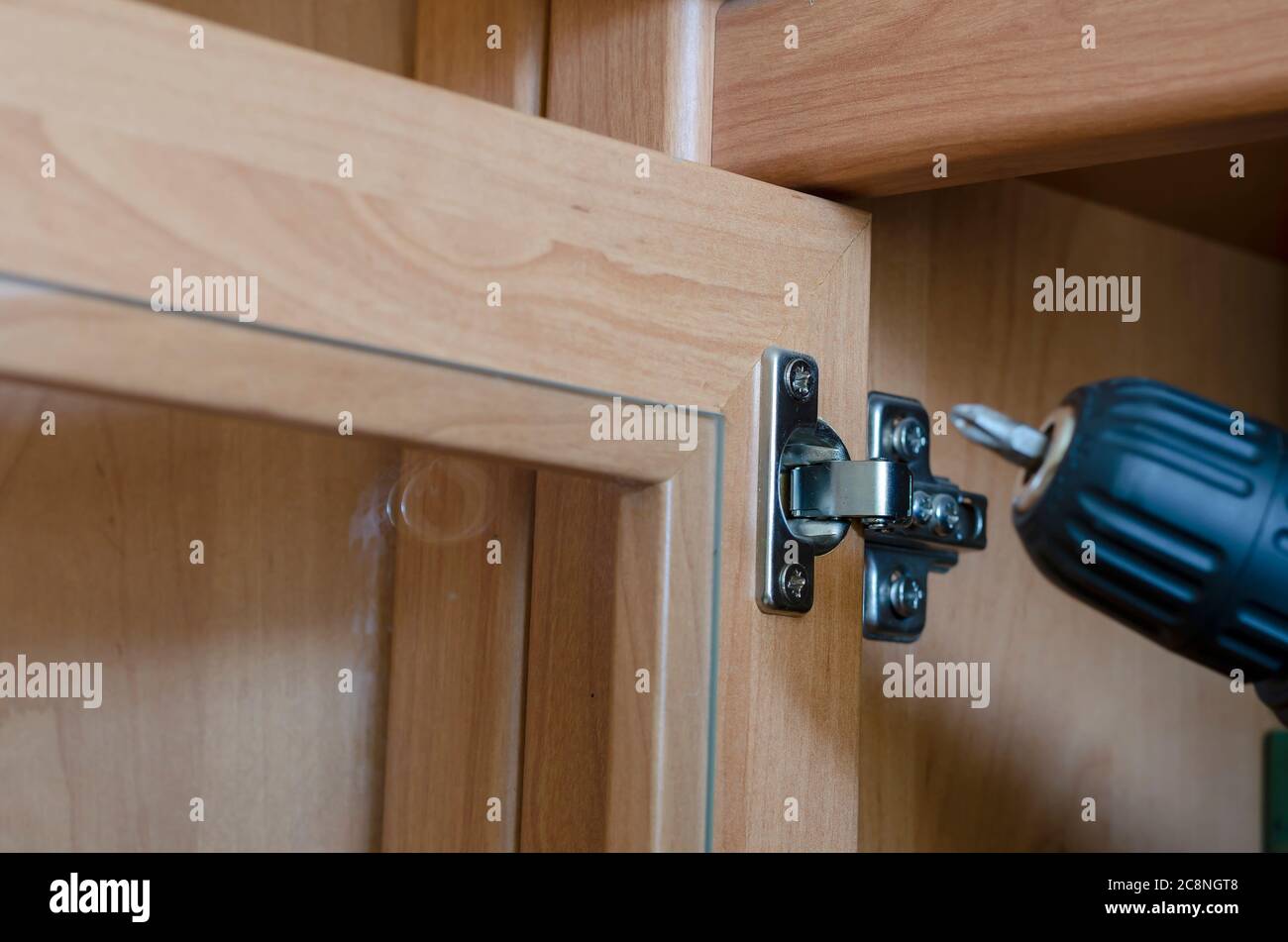 door hinge adjustment. Assembly and repair of furniture using