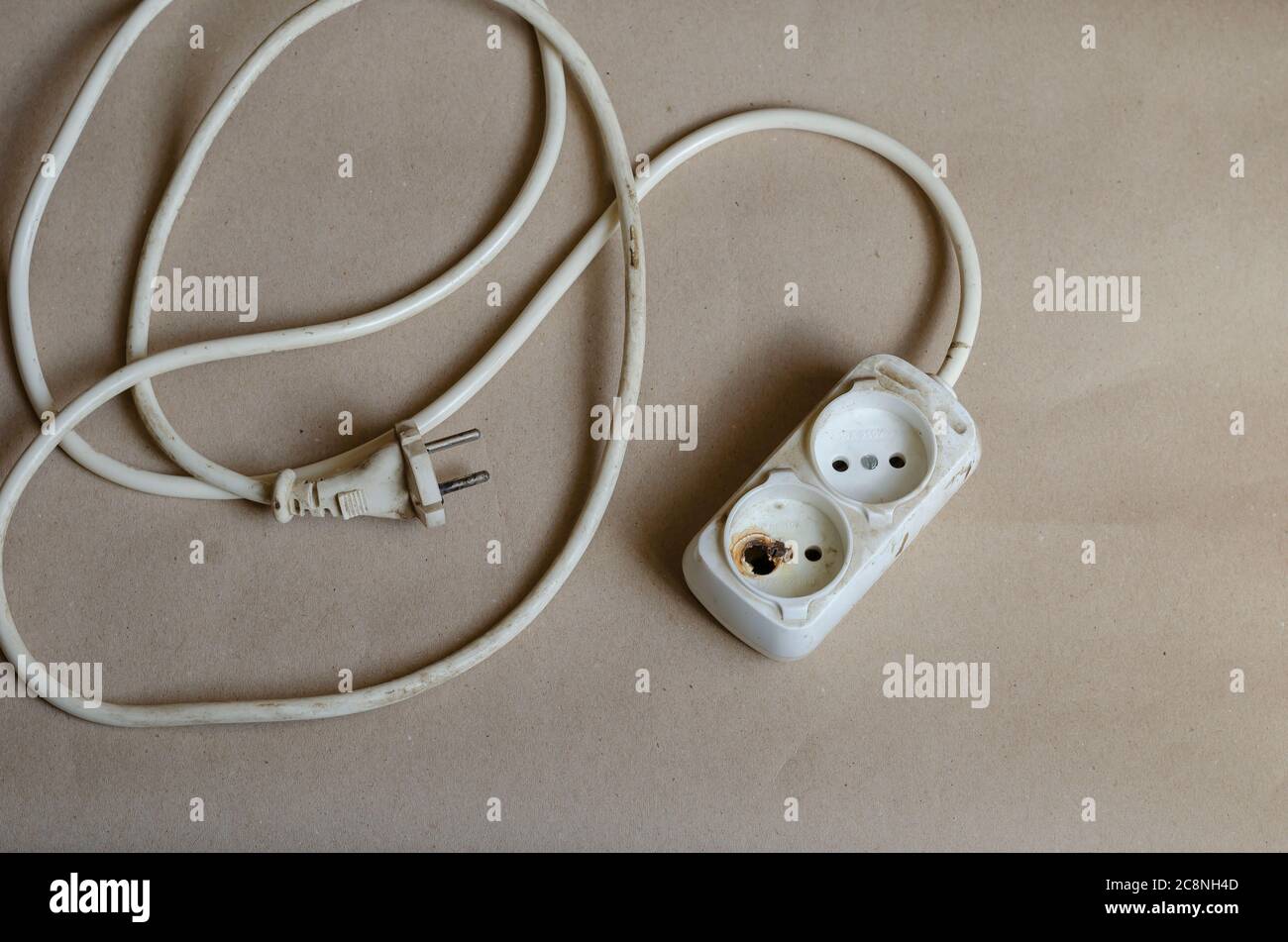 Electrical plug condition ,outlet after shock on brown background