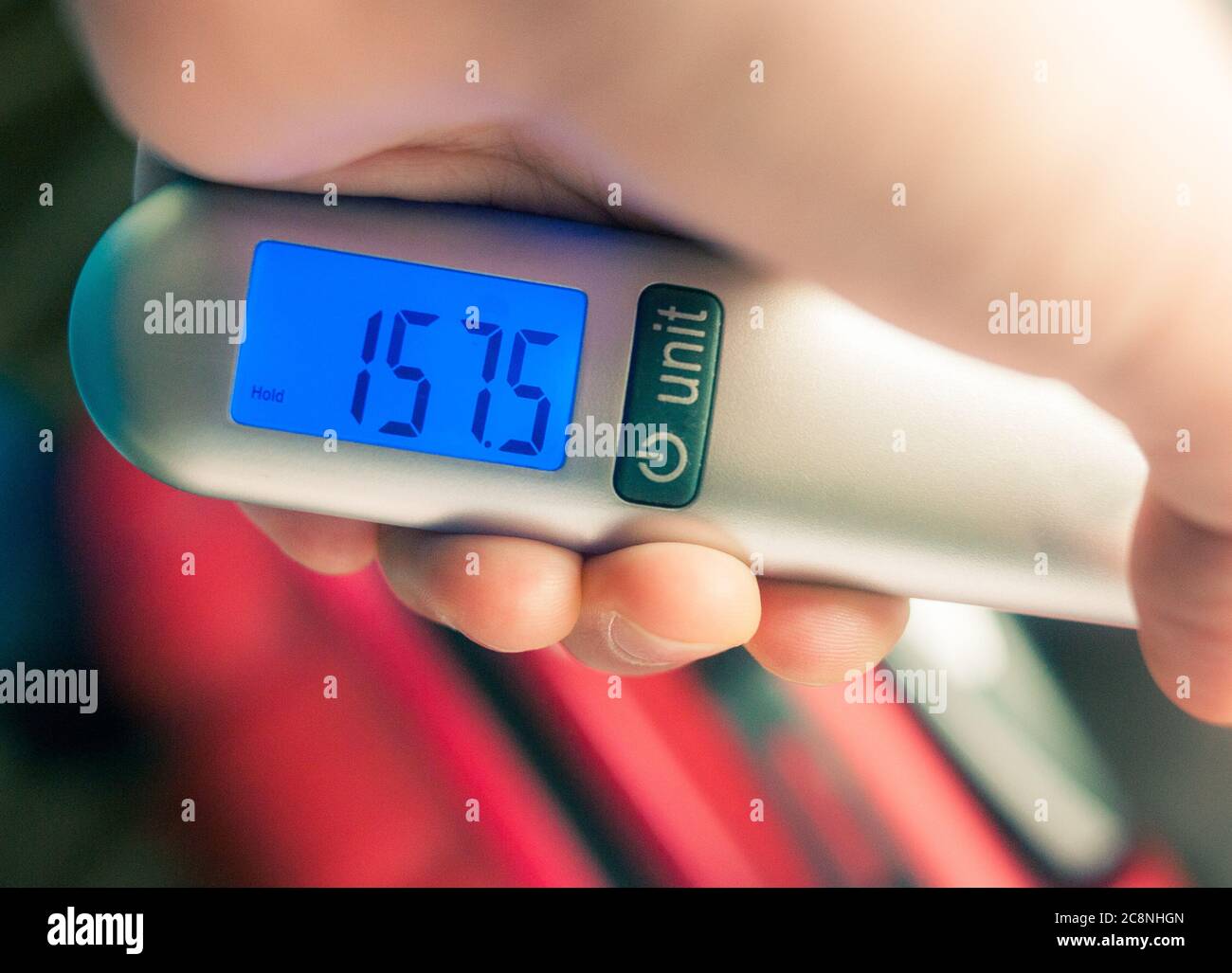 Measuring Luggage With A Hand Scale Stock Photo - Download Image