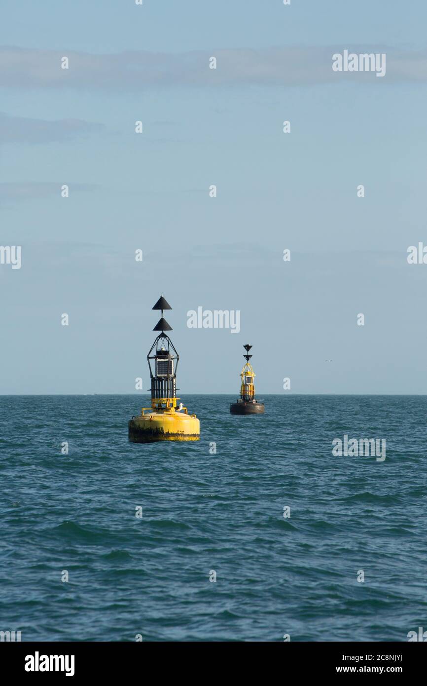 Left to right: A north cardinal buoy and south cardinal buoy off the south coast of Devon. Devon England UK GB Stock Photo