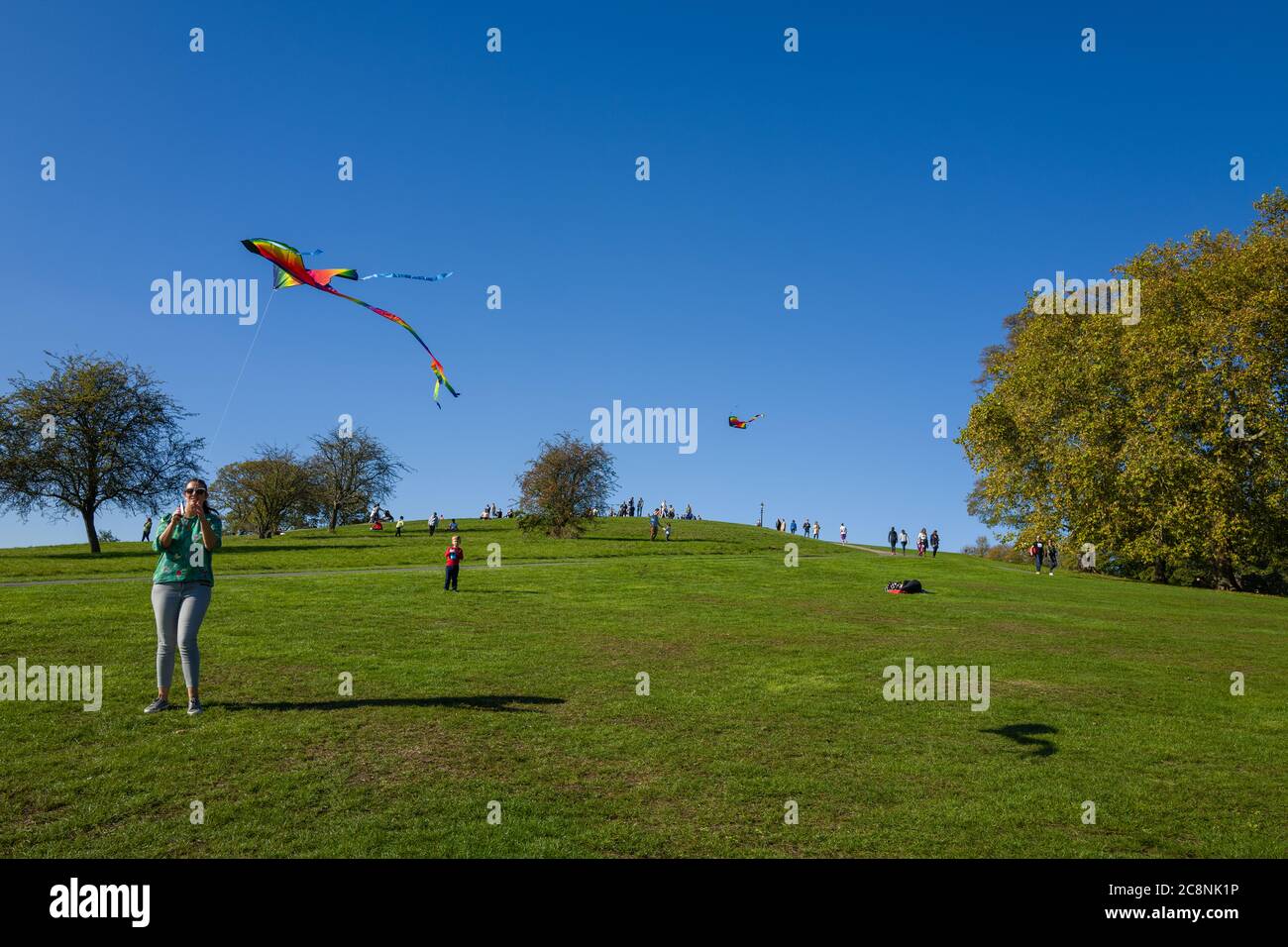 Kites flown on a beautiful sunny autumn day on Primrose Hill, London, UK. Horizontal format. Stock Photo