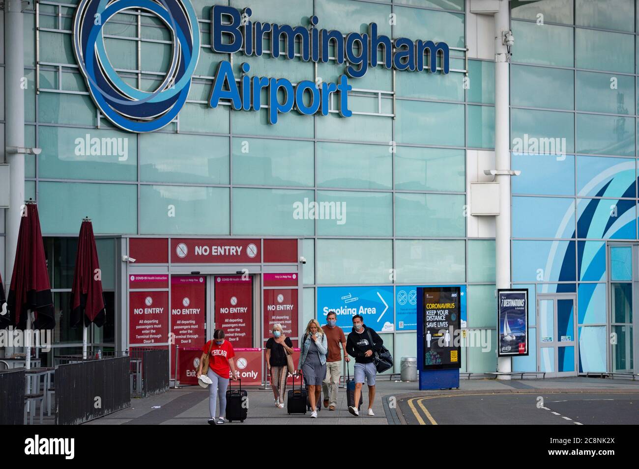 Passengers flying from Barcelona arrive at Birmingham Airport, following an announcement on Saturday that holidaymakers who had not returned from Spain and its islands by midnight would be forced to quarantine for 14 days after Covid-19 second wave fears saw the European country struck off the UK's safe list. The decision was made after Spain recorded more than 900 fresh daily Covid-19 cases for two days running. Stock Photo