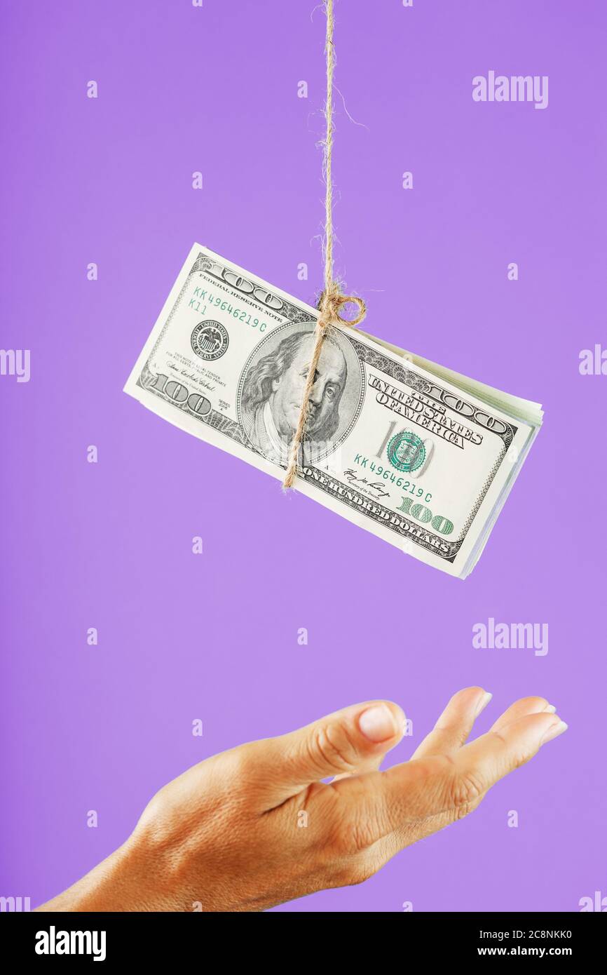 Money Jump Rope Money on a rope above the palm on a pink background Stock Photo - Alamy