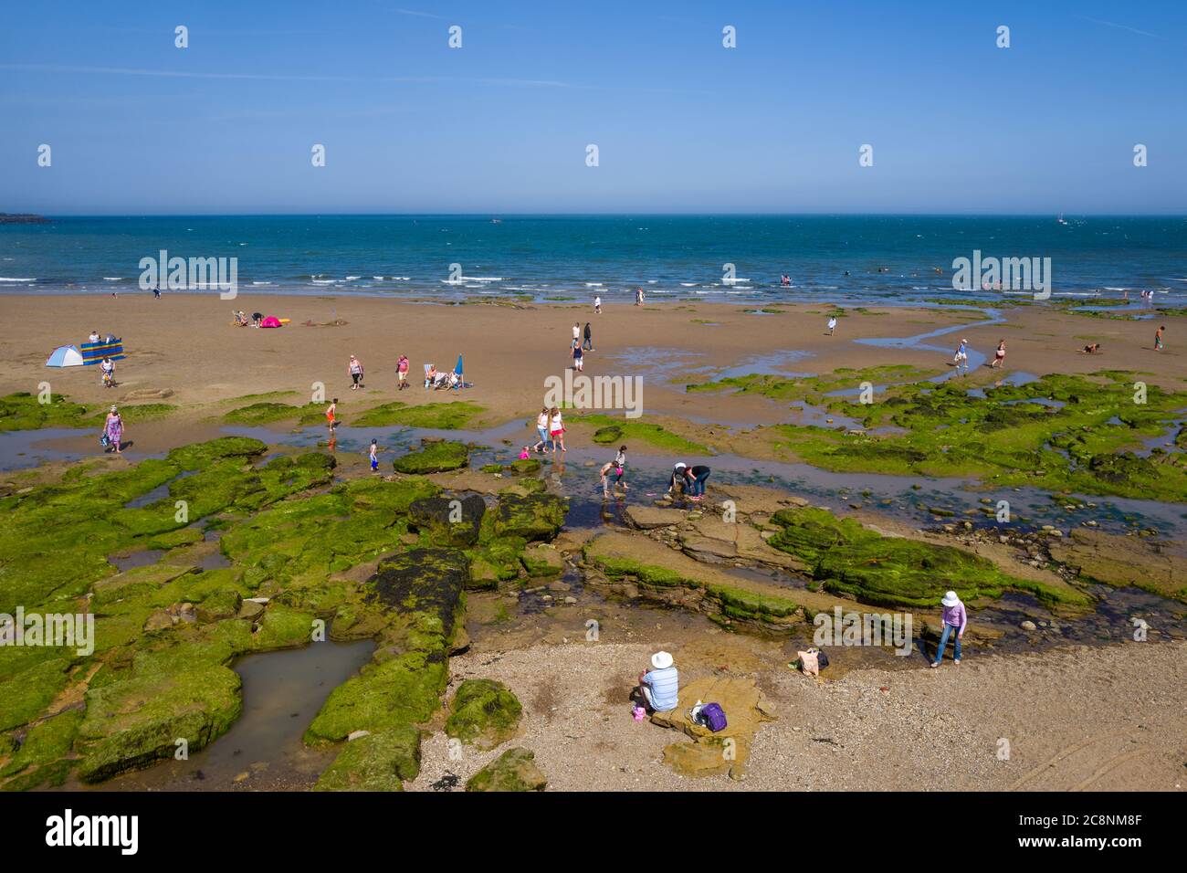 Holidaymakers captured in Lowry style against the backdrop of Scarborough beach on a beautiful, sunny summer day. (1) Stock Photo