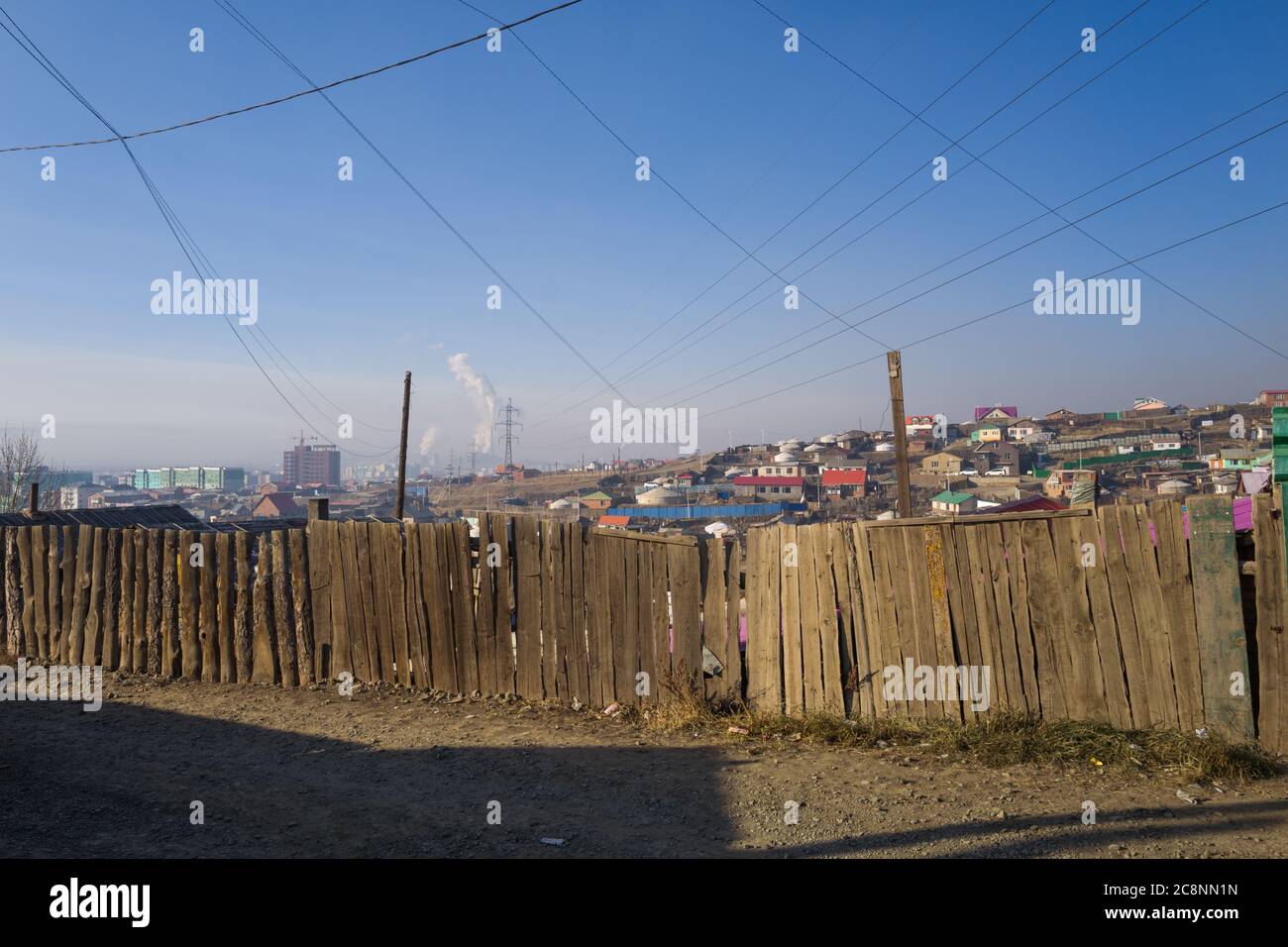 Cityscape of suburb in Ulaanbataar / Ulan Bator, Mongolia. Graphic elements created by lines of telegraph wires and rectangles of a fence. Stock Photo