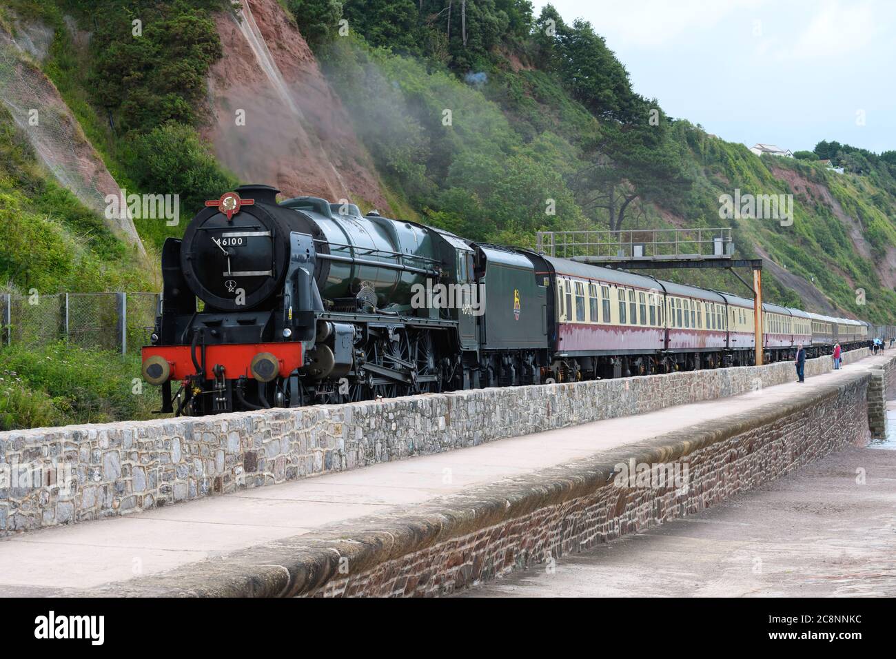 Steam locomotive 46100 Royal Scot hauls the English Riviera Express train past the sea wall Teignmouth south Devon UK Stock Photo