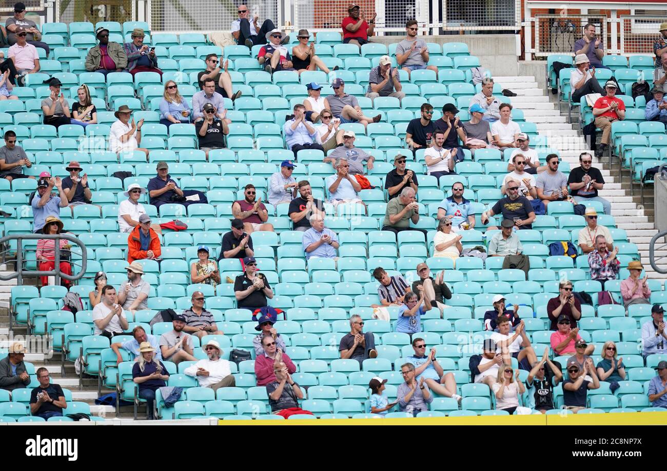 Spectators observe social distancing in the stands during the friendly