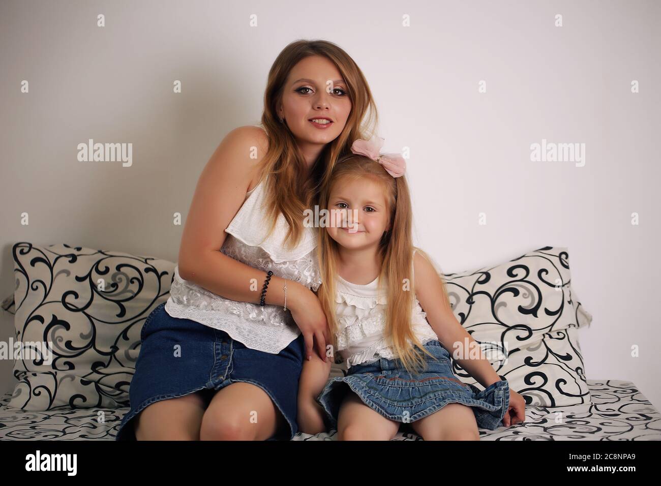Mother and daughter, family, loving mother hugging at home Stock Photo