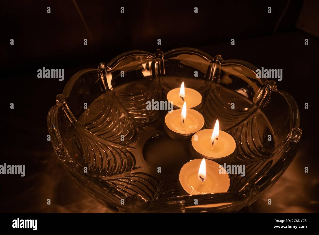 Fortune telling with floating candles. 4 burning candles float in a