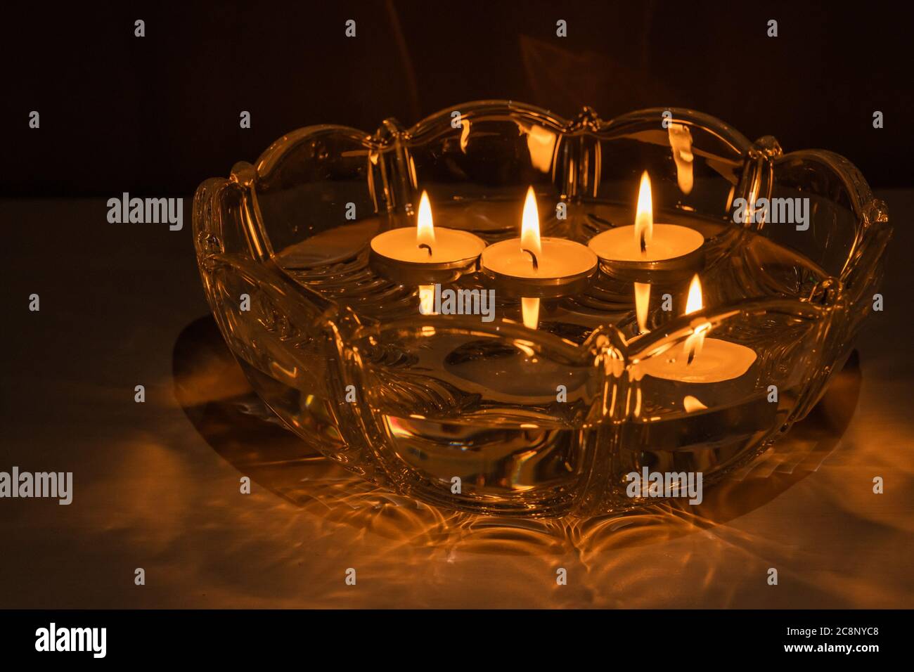 Fortune telling with floating candles. 4 burning candles float in a