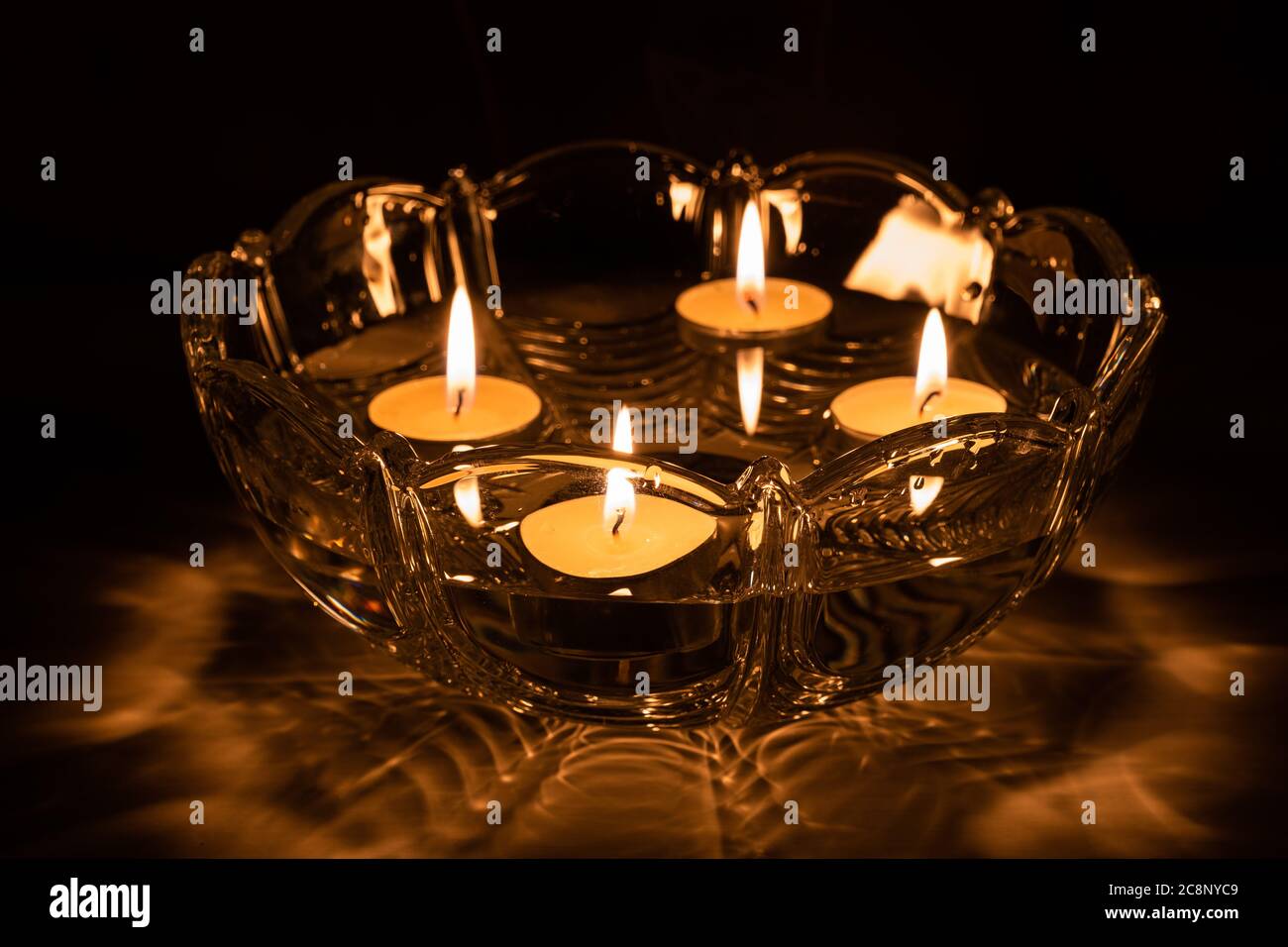 Fortune telling with floating candles. 4 burning candles float in a