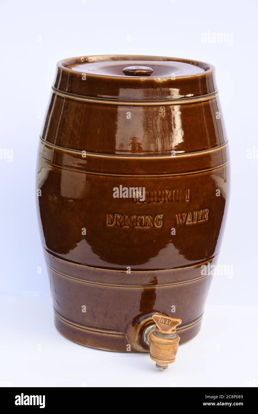 Brown stoneware salt glazed barrel,marked Etherium Drinking water.With Stoneware spigot. tap. Stock Photo
