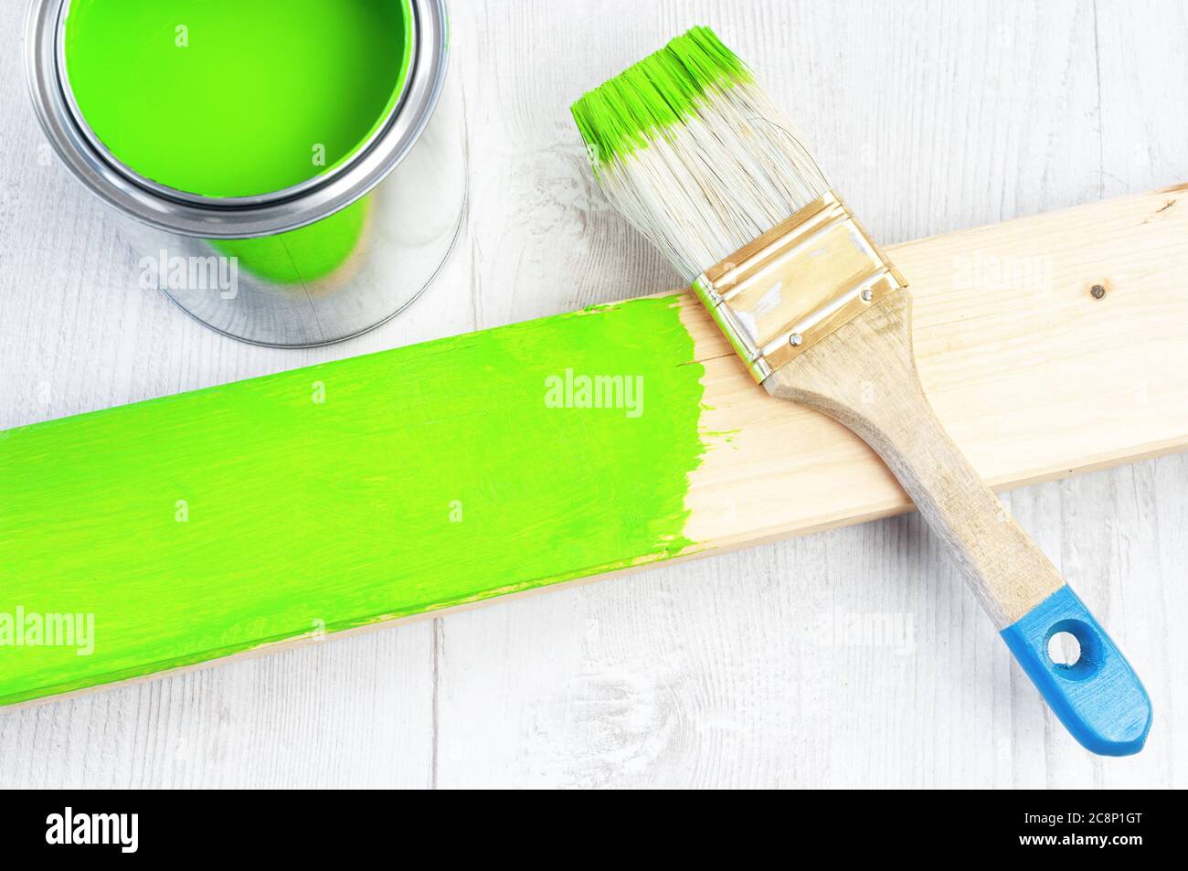 Paint brush and can on wooden surface Stock Photo