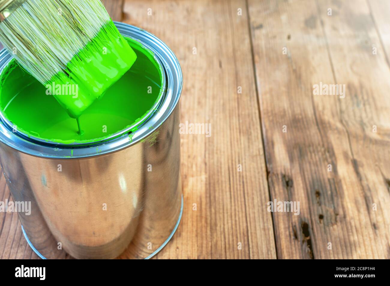 Paint brush and can on wooden surface Stock Photo