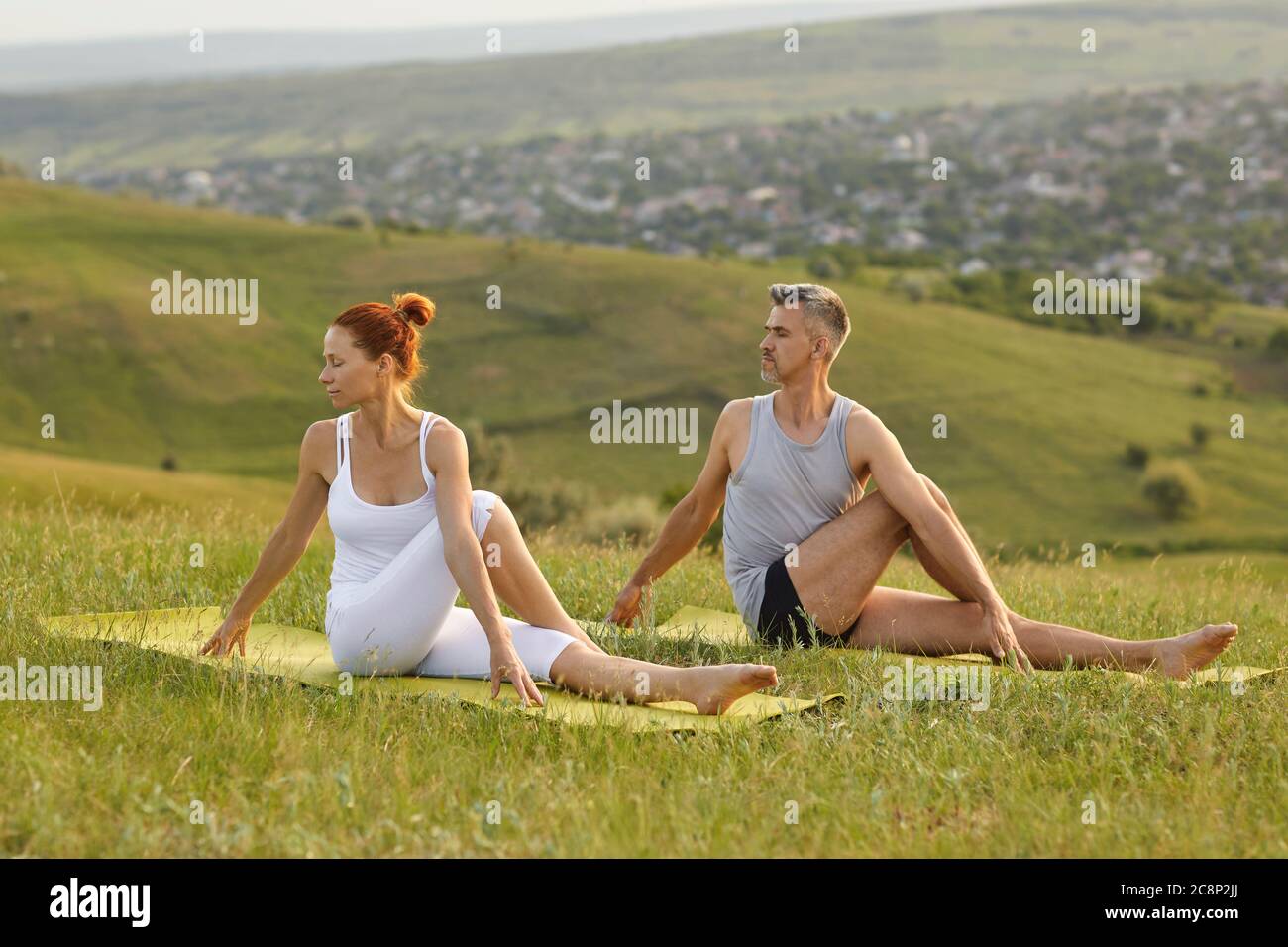 Adult couple stretching bodies in summer spring nature Stock Photo